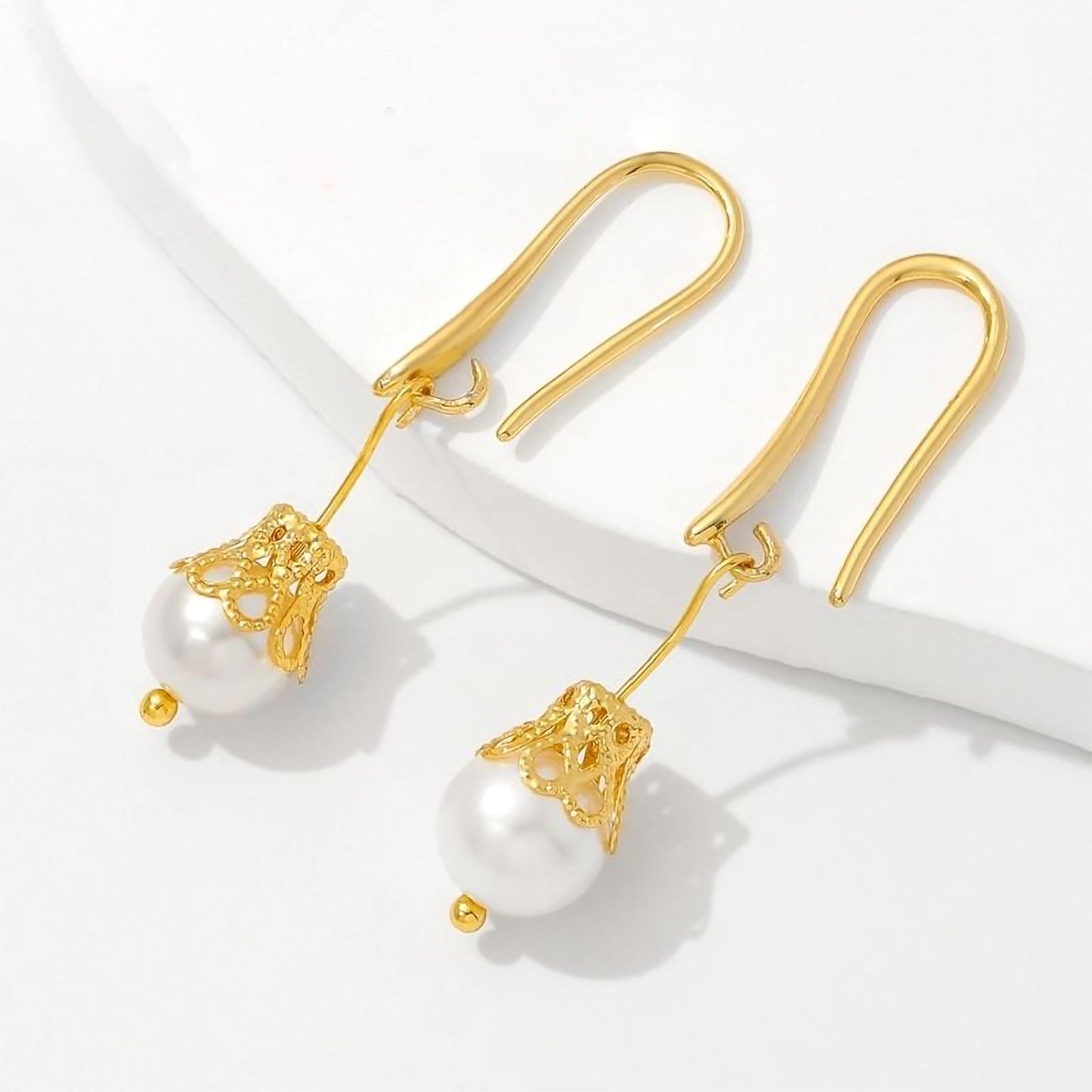 Metallic gold flower bead caps add neat finishing detail to jhumka making and latkan work.
