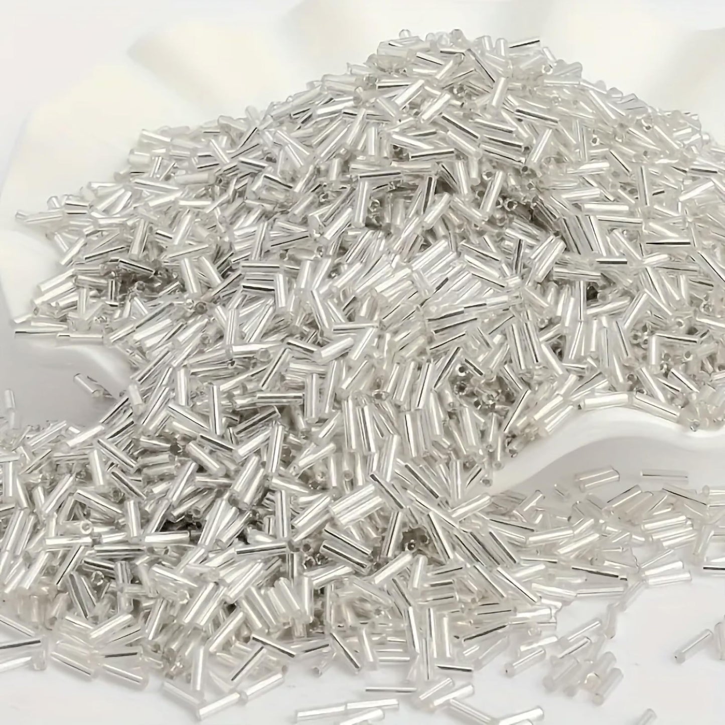 Use white and silver 5mm bugle small cut cylinder silverline tubes 5mm shiny to finish DIY craft projects, creative hobby work and decorative handmade designs with a clean.