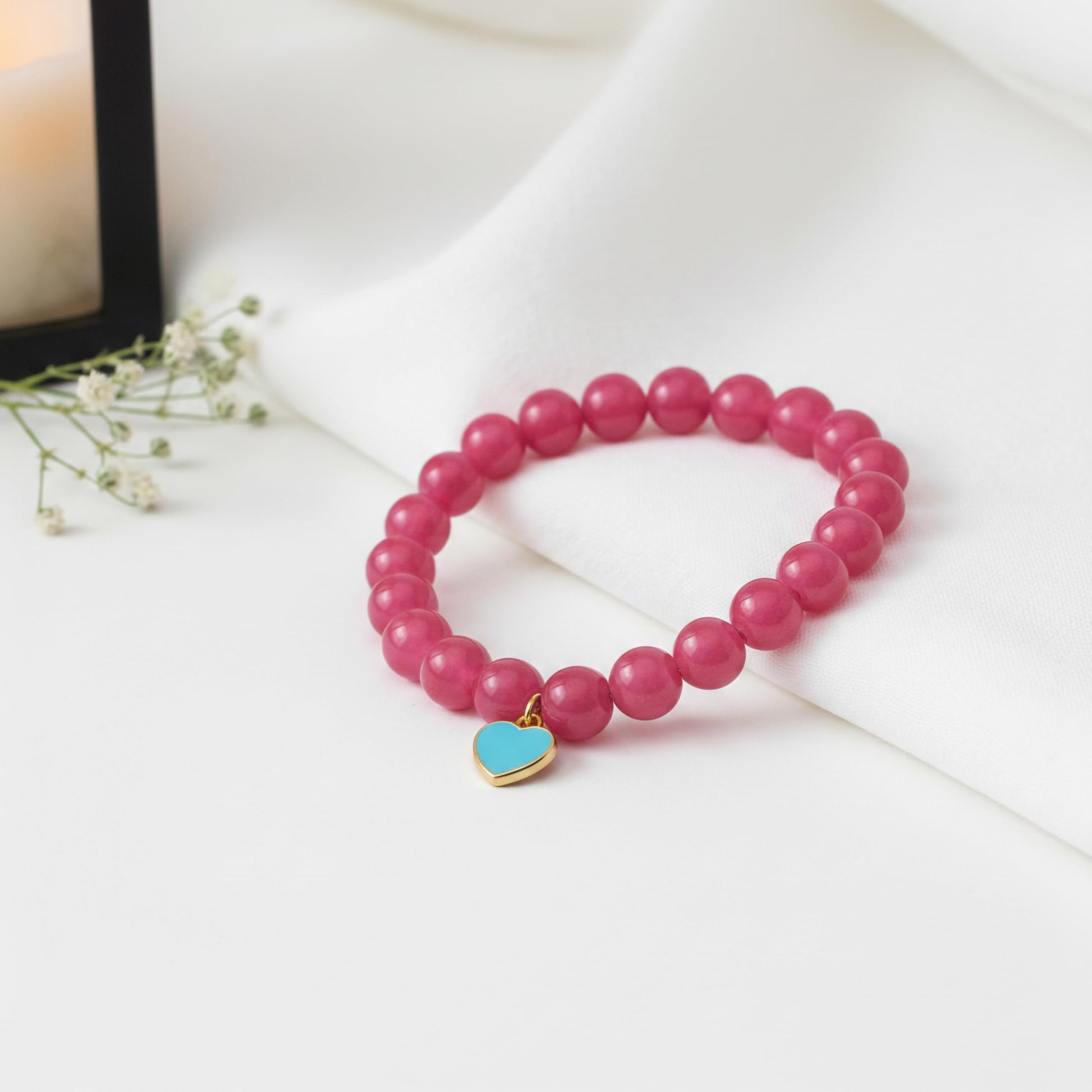 Bring cute charm detail to casual outfits with a ruby beaded bracelet for girls and women.