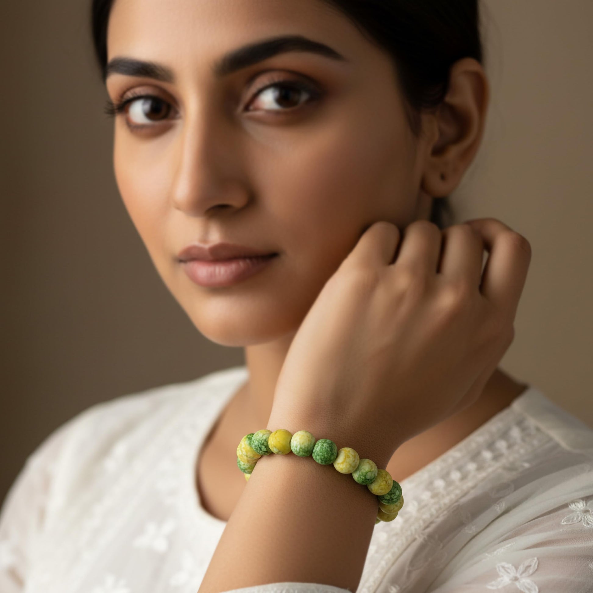 Create a fresh friendship-band look using yellow and green marble beads and easy stretch styling.