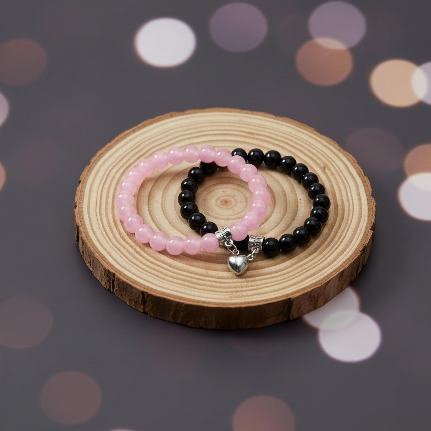 Keep couple looks cute and coordinated with black and pink 1-pair heart-link magnetic bracelets.