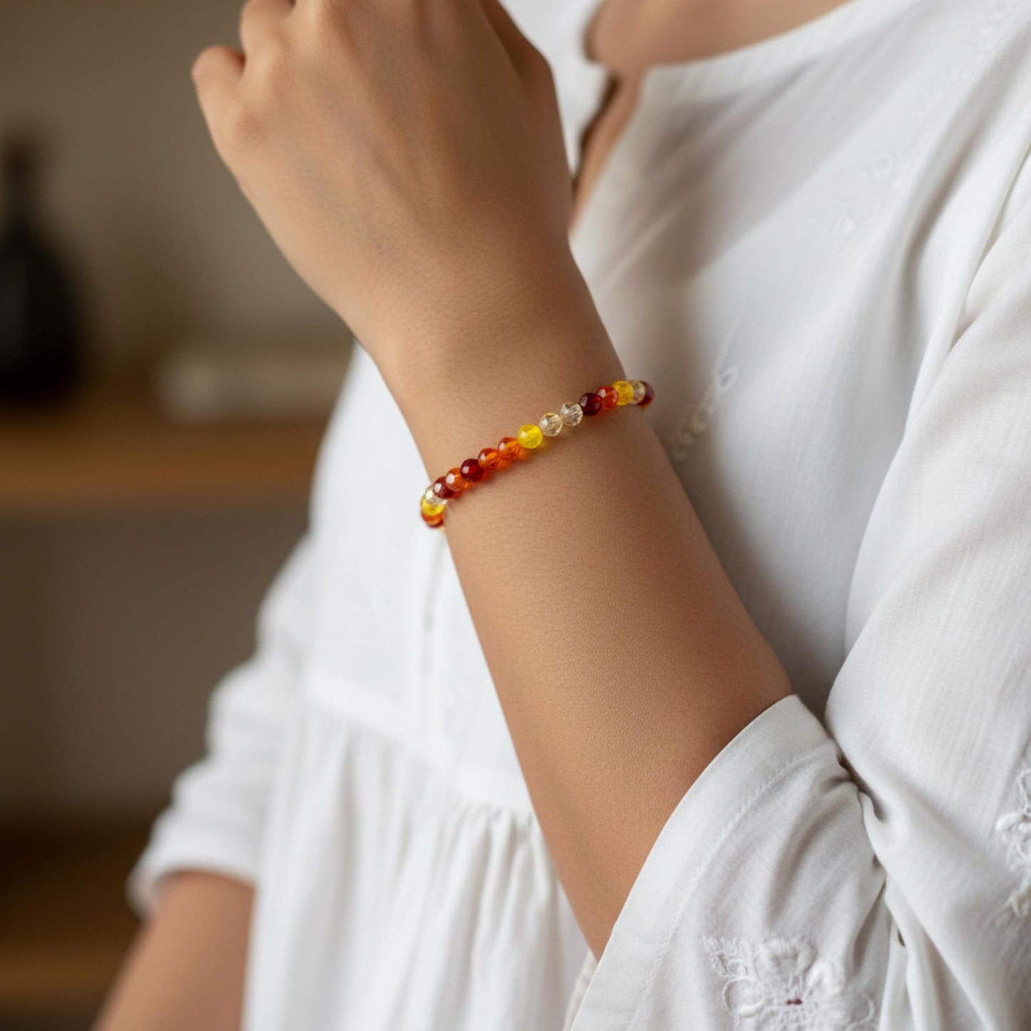 Create a bright friendship accessory look using orange bicone beads and stretch bracelet styling.
