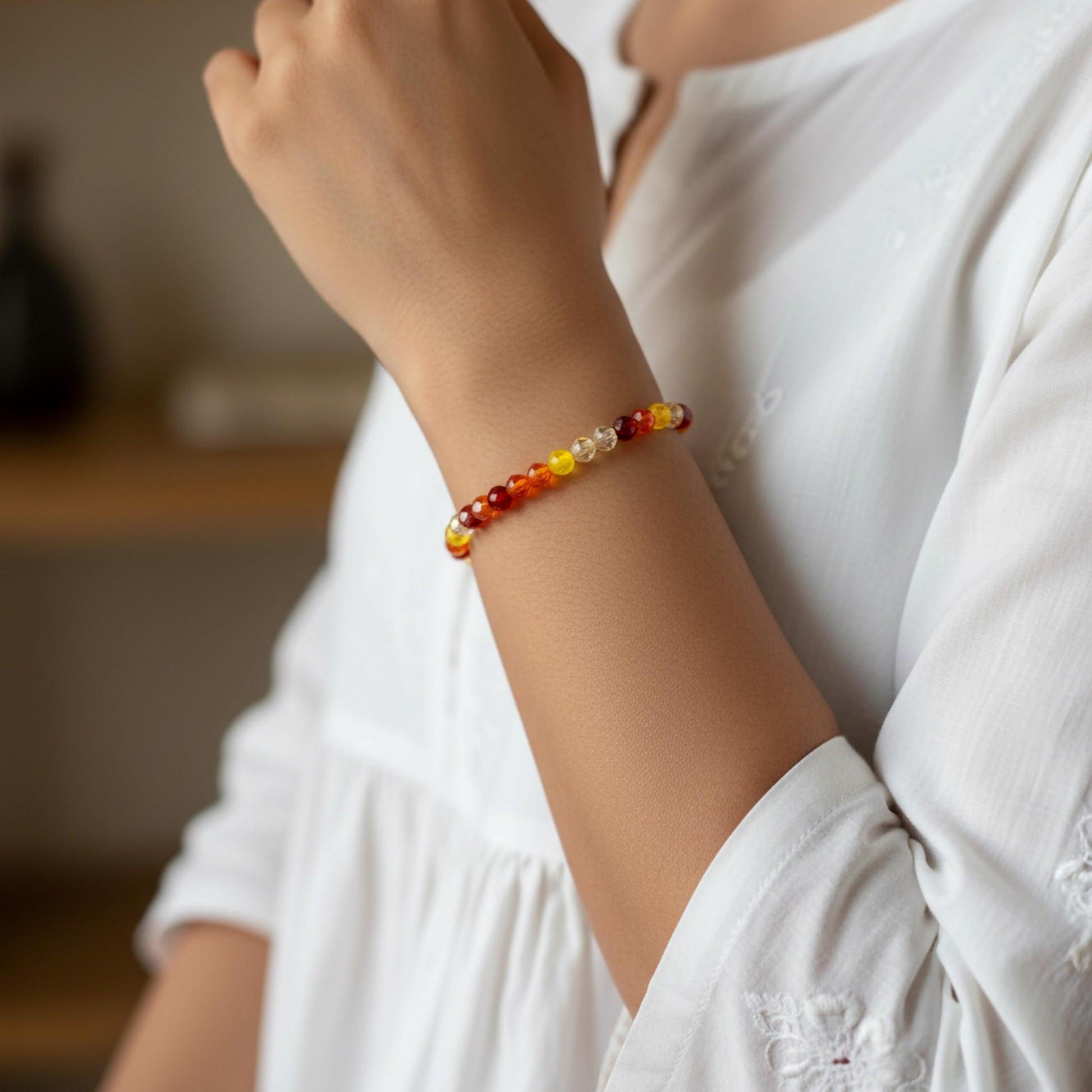 Create a bright friendship accessory look using orange bicone beads and stretch bracelet styling.