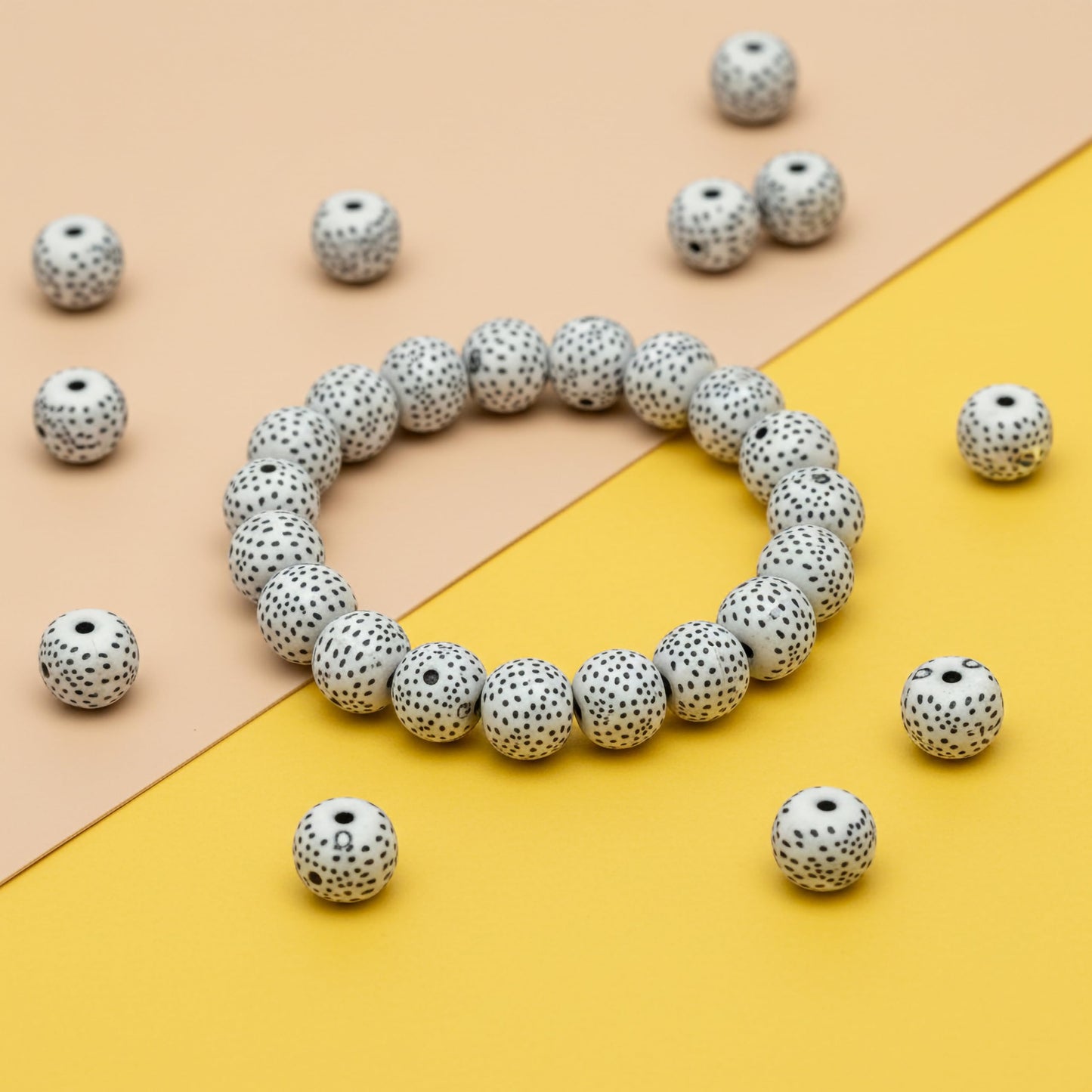 DIY craft beads with black dot pattern on white base