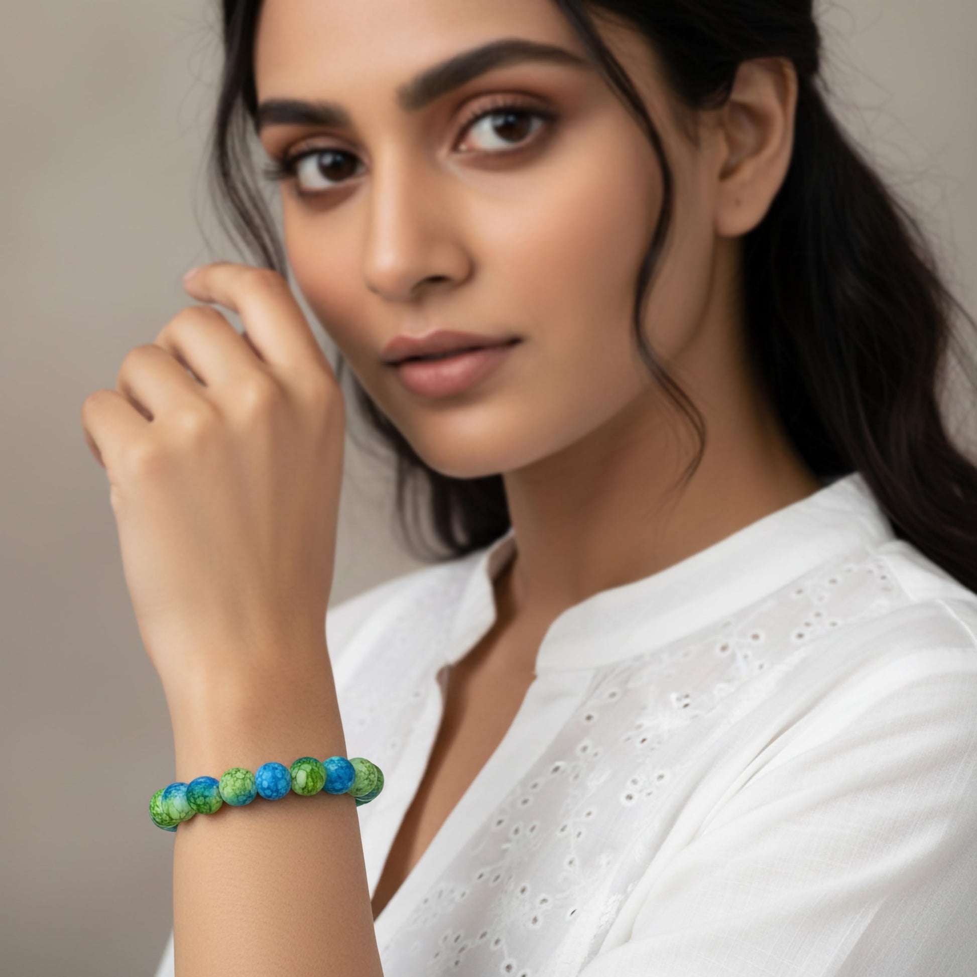 Create a fresh friendship-band look using green and blue marble beads and easy stretch styling.