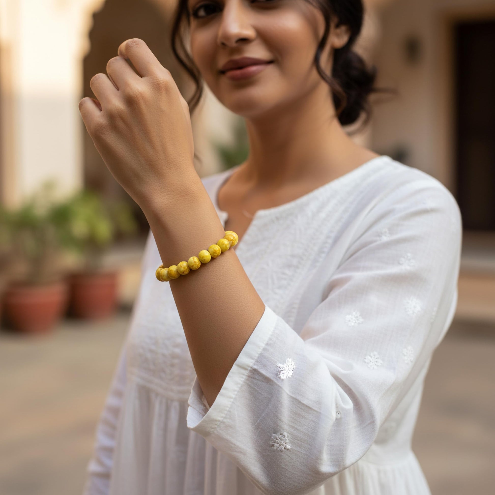 Create a fresh friendship-band look using yellow marble beads and easy stretch styling.
