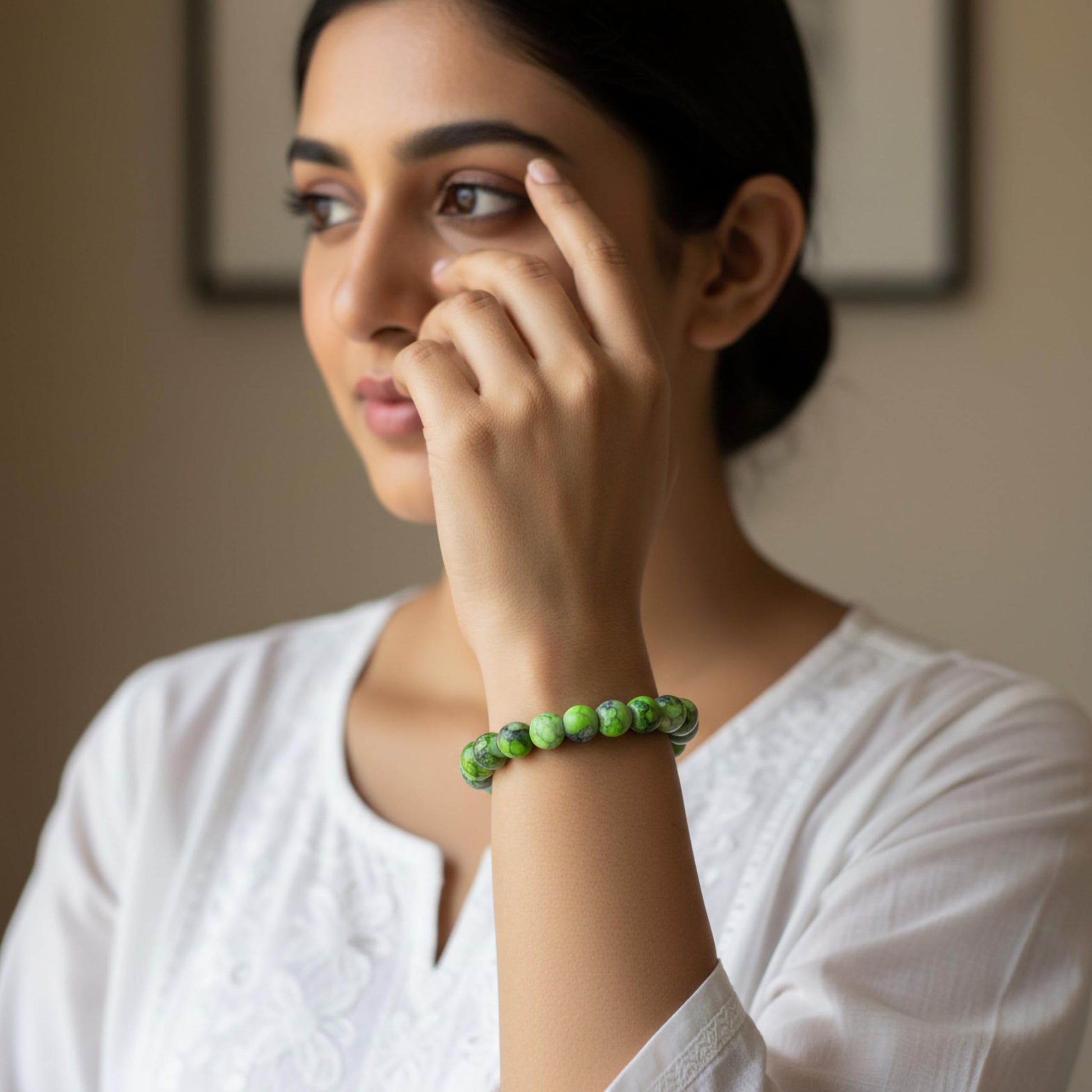 Create a fresh friendship-band look using green and black marble beads and easy stretch styling.