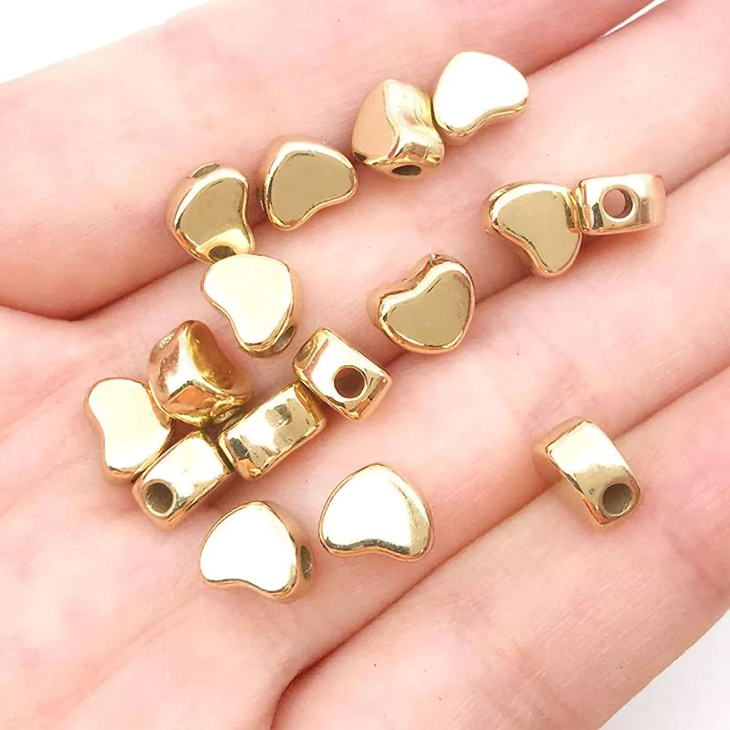 Heart gold and silver plastic and acrylic beads help finish necklace making and DIY jewellery projects with a refined look.