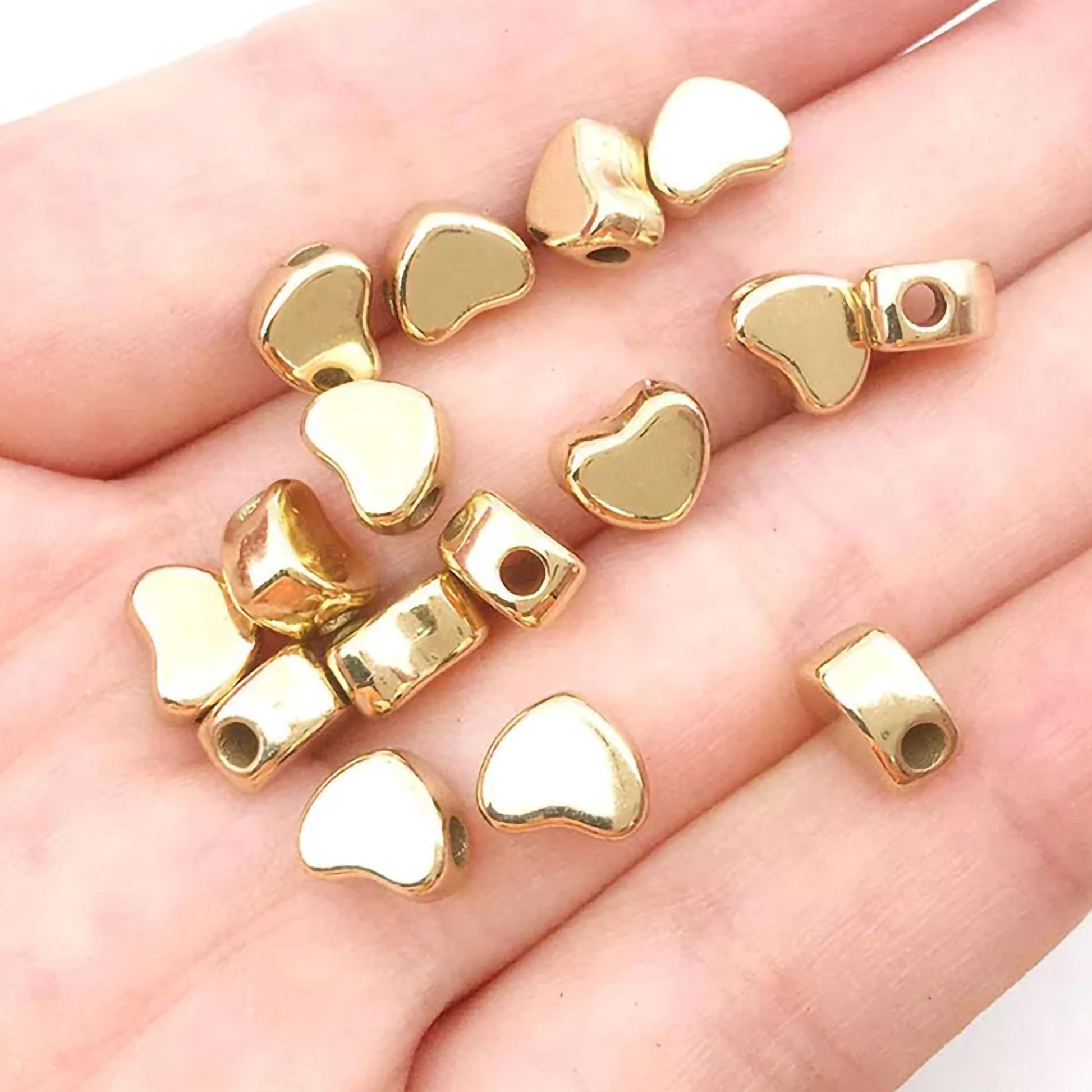 Heart gold and silver plastic and acrylic beads help finish necklace making and DIY jewellery projects with a refined look.