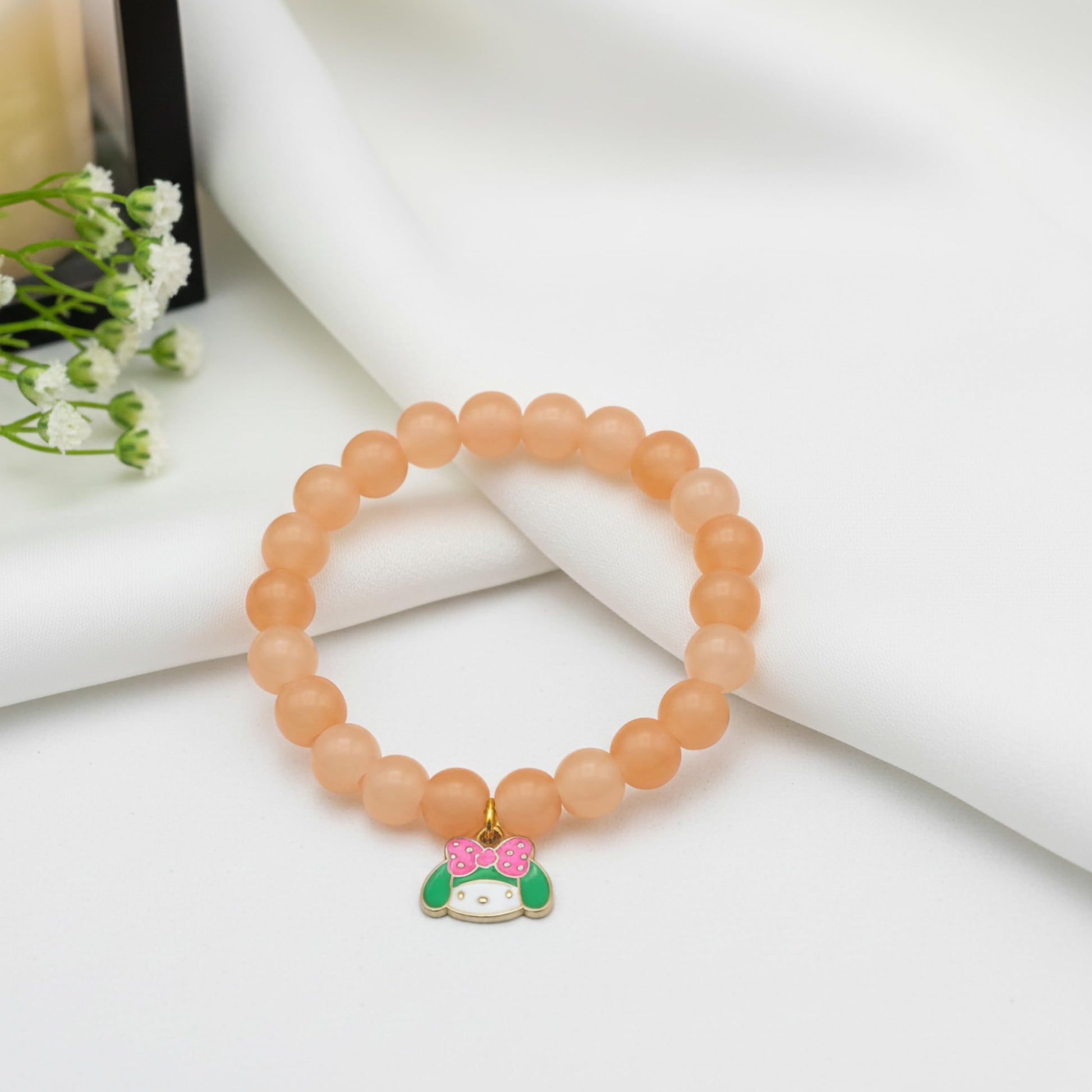 Gift a light and cheerful bracelet style with peach beads and comfortable elastic wear.