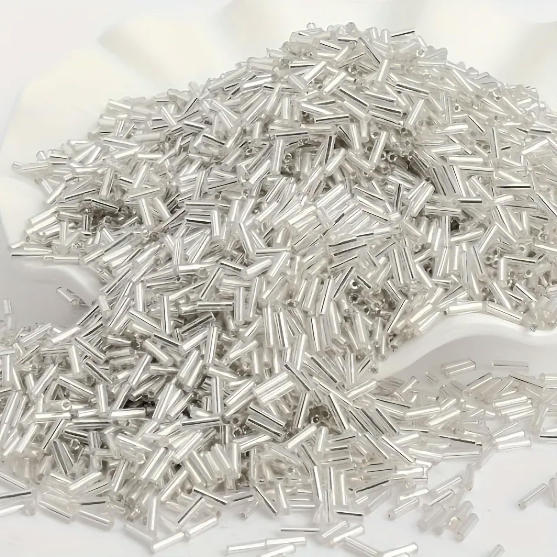 Use white and silver 5mm bugle small cut cylinder silverline tubes 5mm shiny to finish DIY craft projects, creative hobby work and decorative handmade designs with a clean.