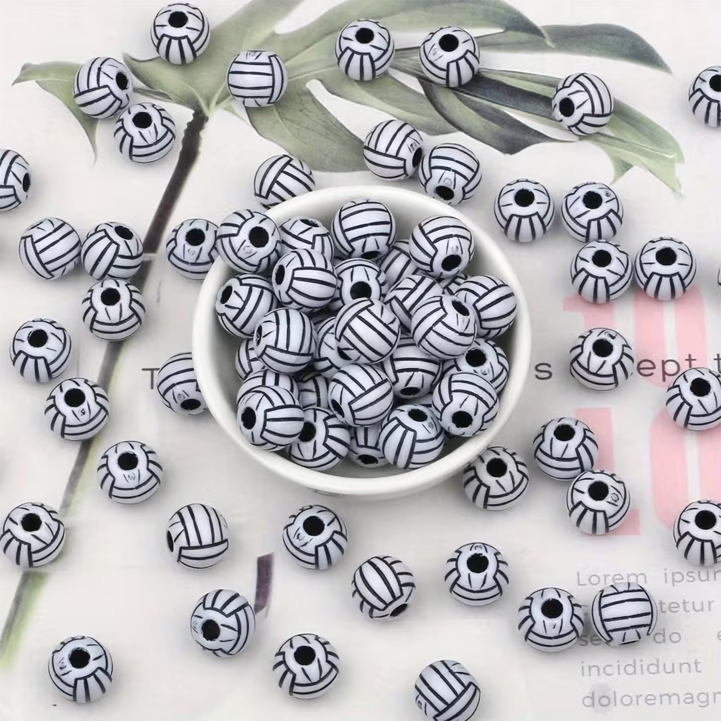 Decorative black beads with white volleyball line detailing
