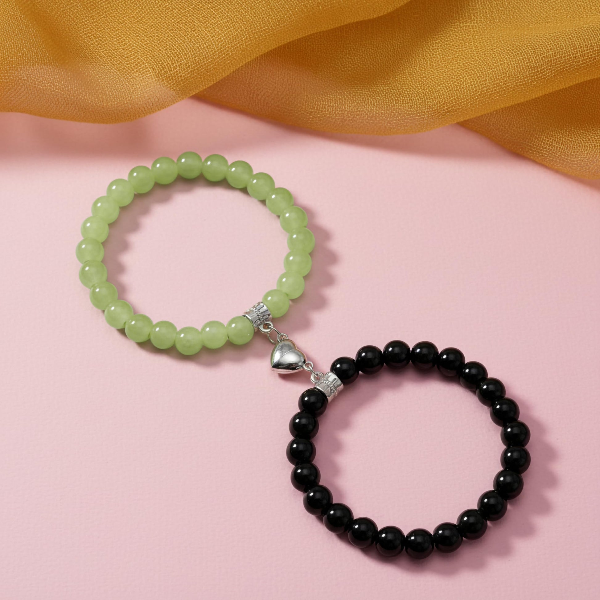 Keep BFF looks cute and coordinated with black and green 1-pair heart-link magnetic bracelets.