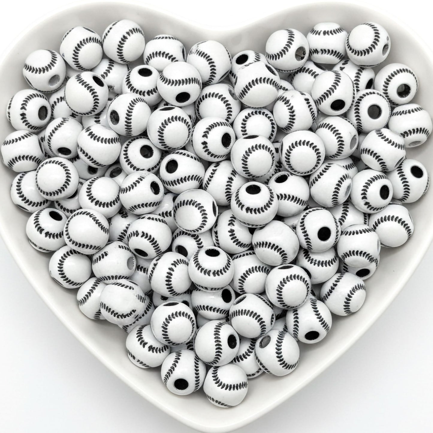 White baseball pattern round beads in heart shaped tray