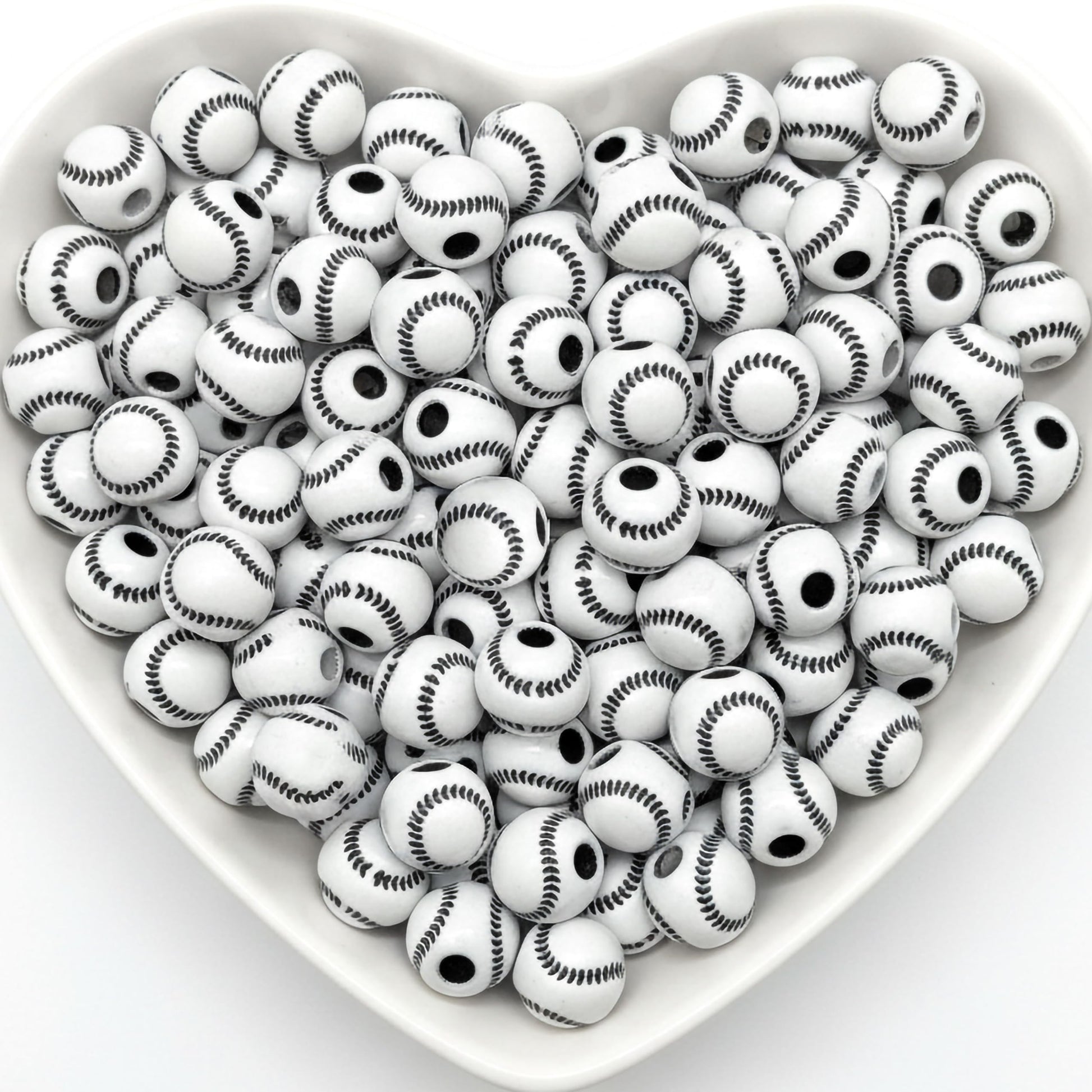 White baseball pattern round beads in heart shaped tray