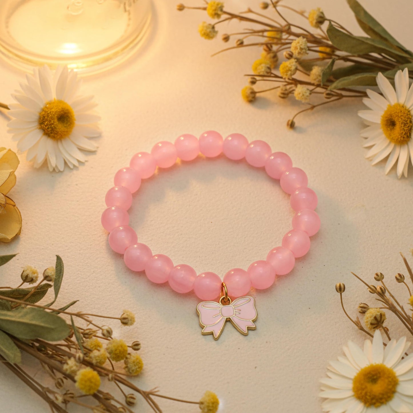 Bring cute charm detail to casual outfits with a pink beaded bracelet for girls and women.
