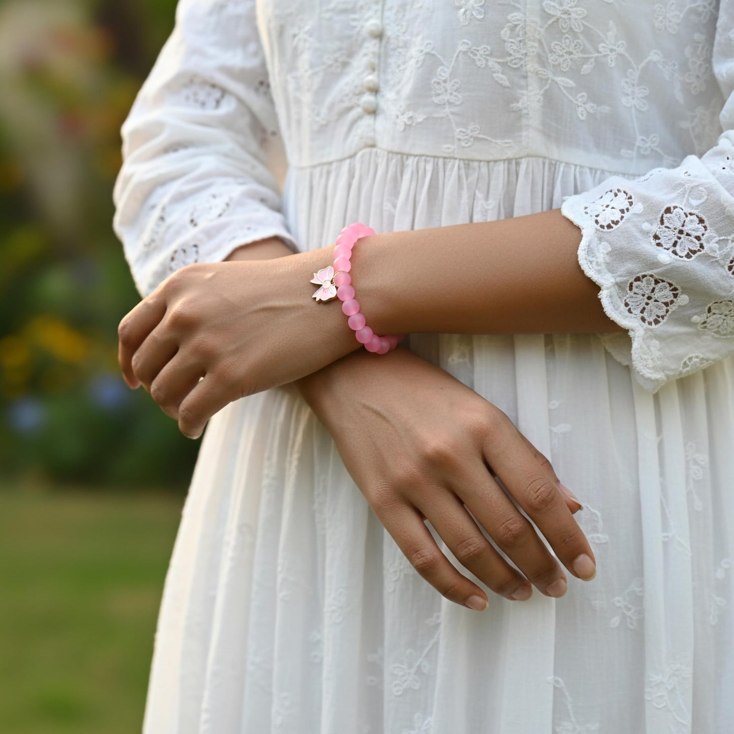 Create easy everyday accessory looks using a pink stretch bracelet with glossy beads.