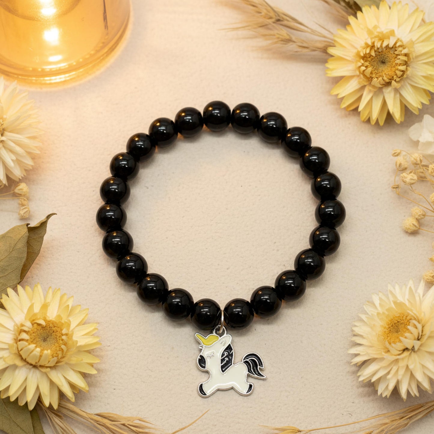 Bring cute charm detail to casual outfits with a black beaded bracelet for girls and women.