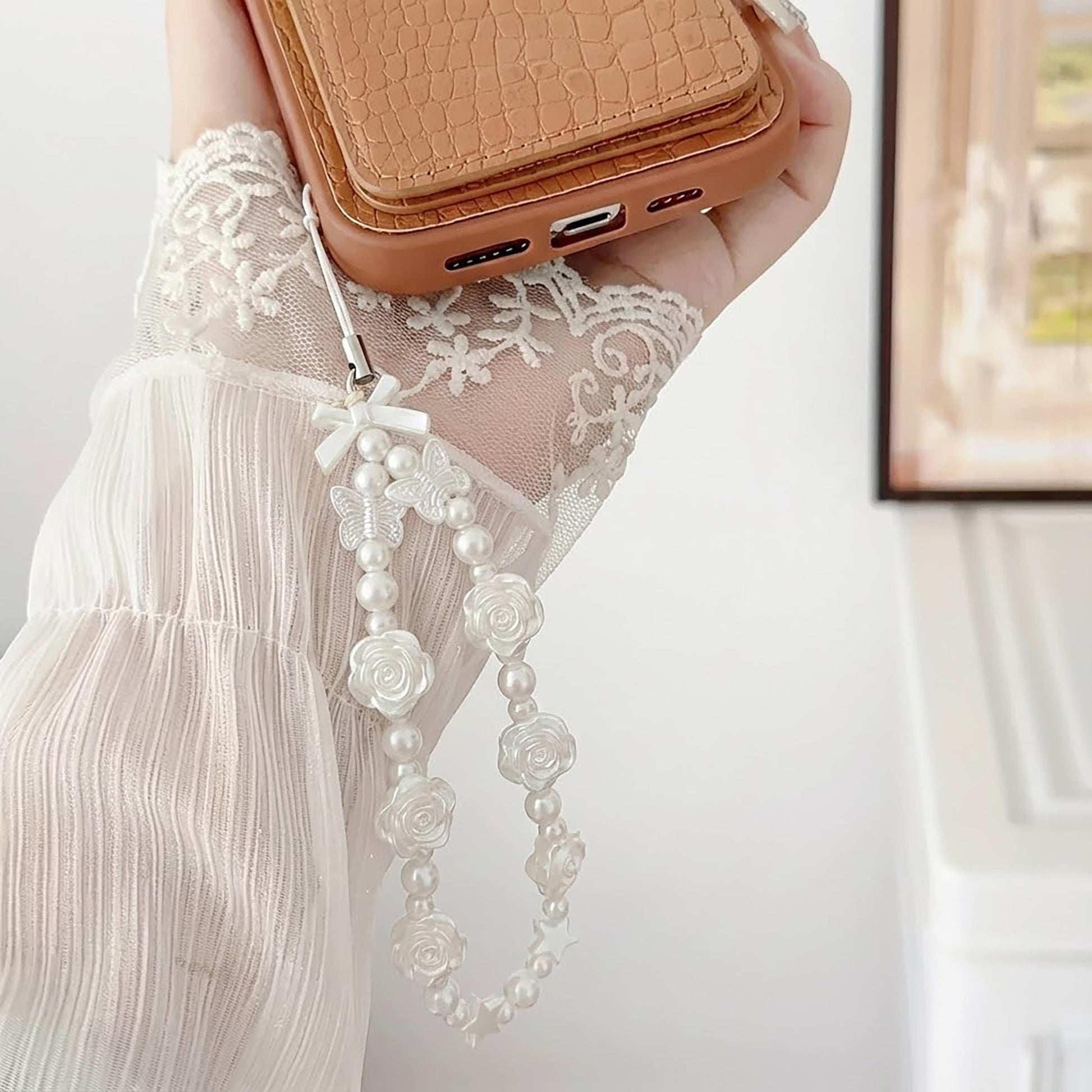 White Cell Phone Mobile Strap with Crystal Beads. Close-up image showing color, shape, finish, and texture details.