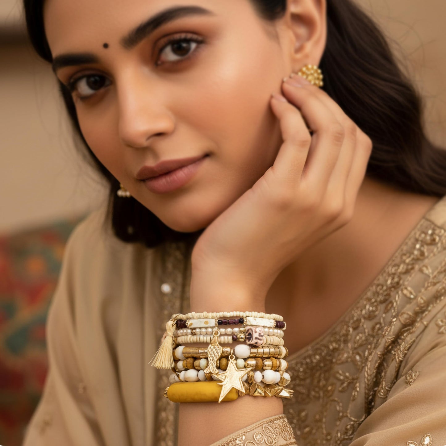 Add relaxed summer style to outfits using a white shell charm bracelet with layered beads.