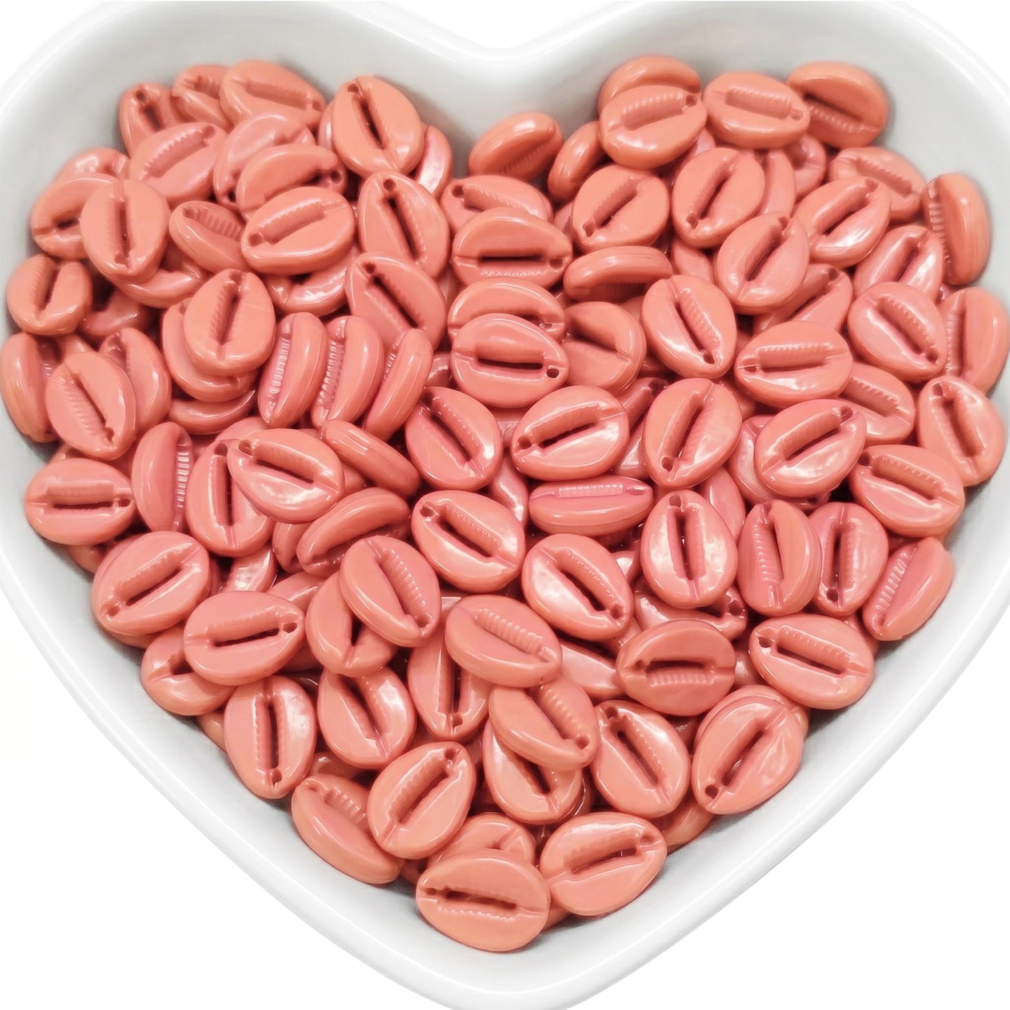 Make handmade jewelry feel warm and beachy with peach cowrie beads for creative designs.