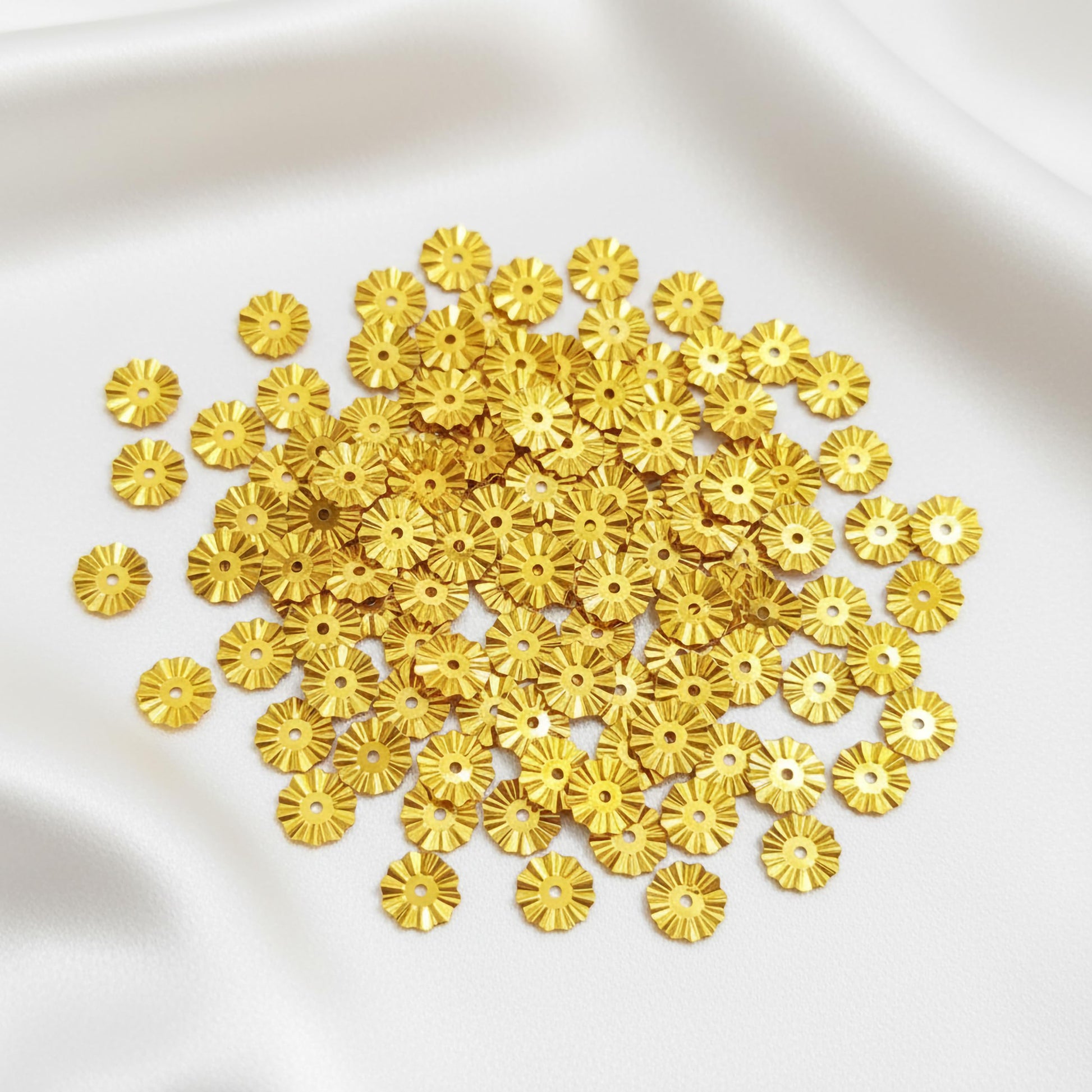 Use 5mm gold aari work sparkle pieces to add metallic texture to dress decoration and boutique craft projects.