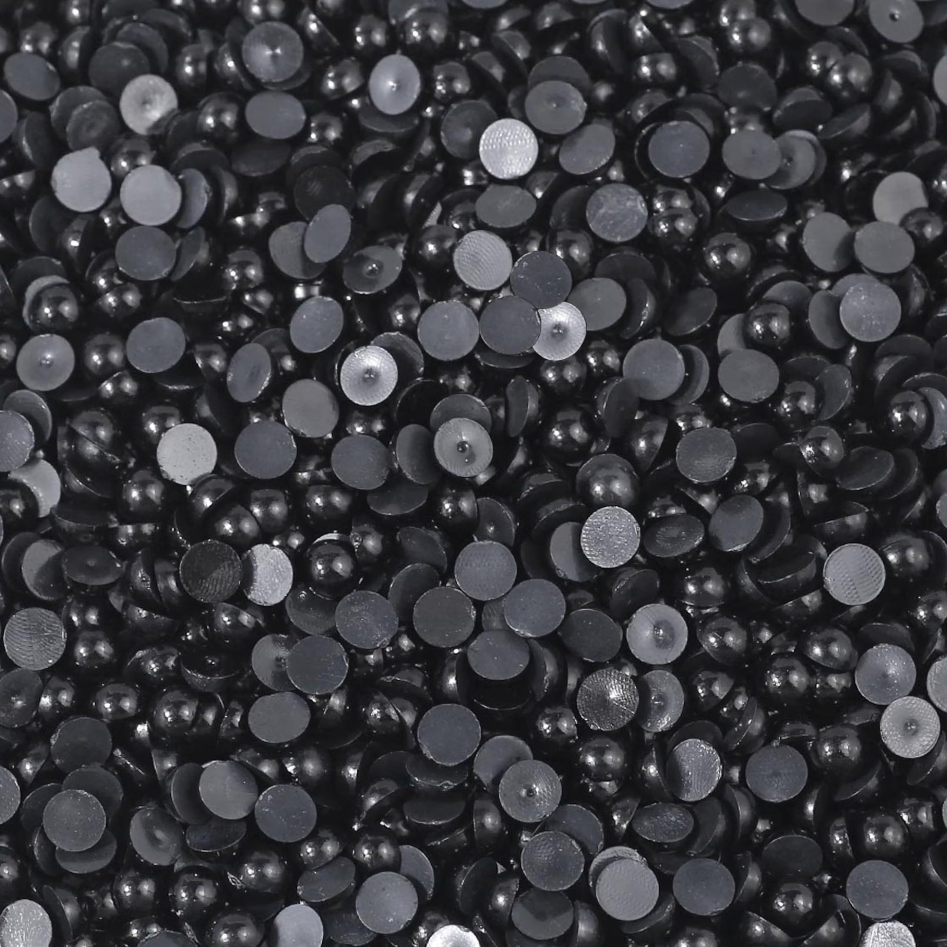 Smooth black flatback pearls turn phone case art into more expressive craft work.