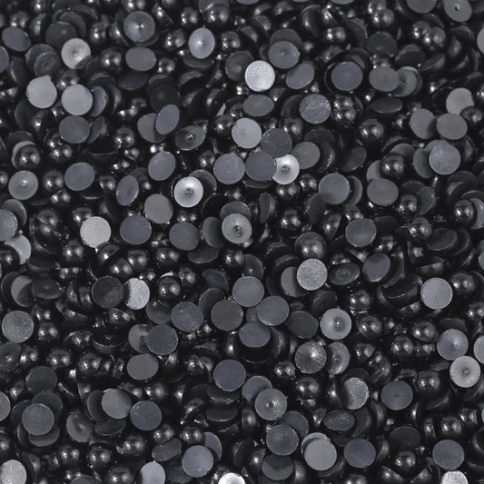 Smooth black flatback pearls turn phone case art into more expressive craft work.