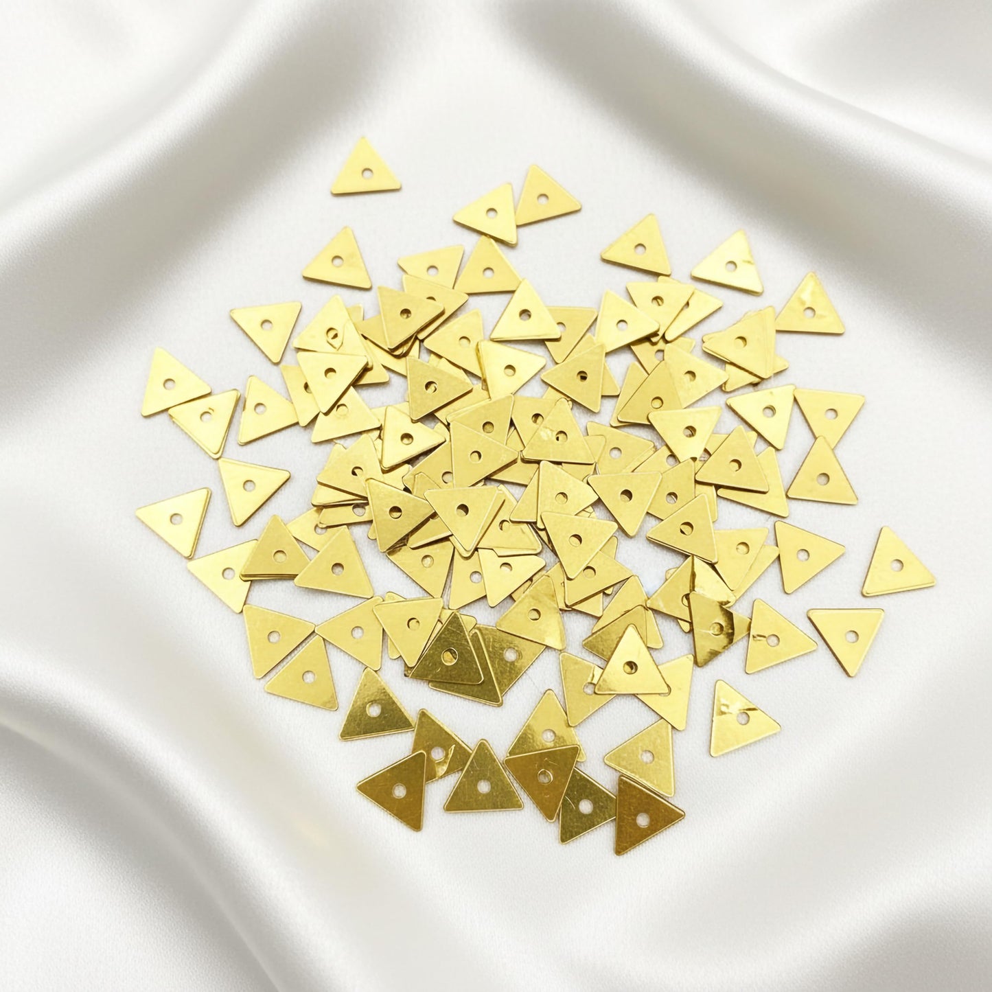 Make dress decoration feel complete with metallic gold triangle chamki pieces for boutique craft projects.