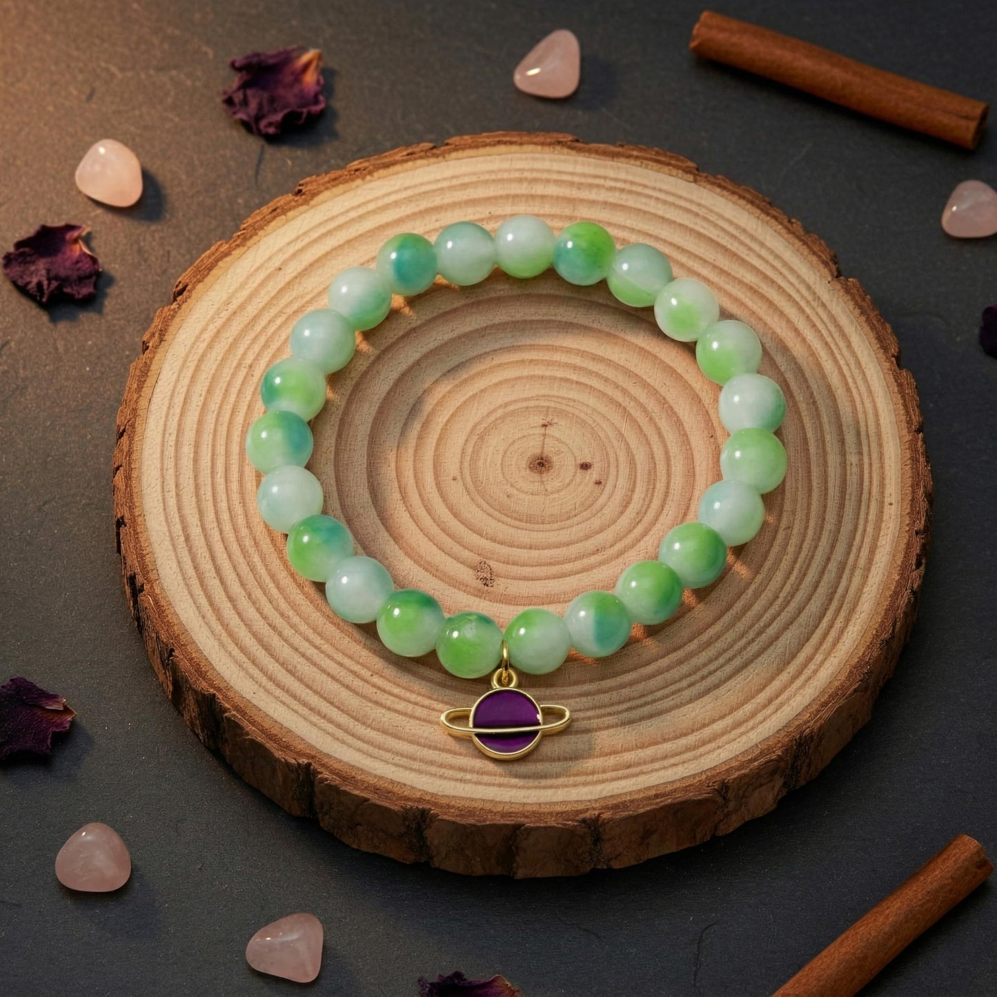 Layer cute wrist stacks with green dualtone bead details and charm accents.