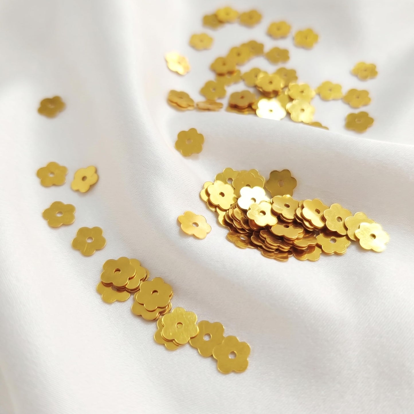 Choose 7mm gold flower embroidery sequins to add metallic texture across dress decoration and boutique craft projects.