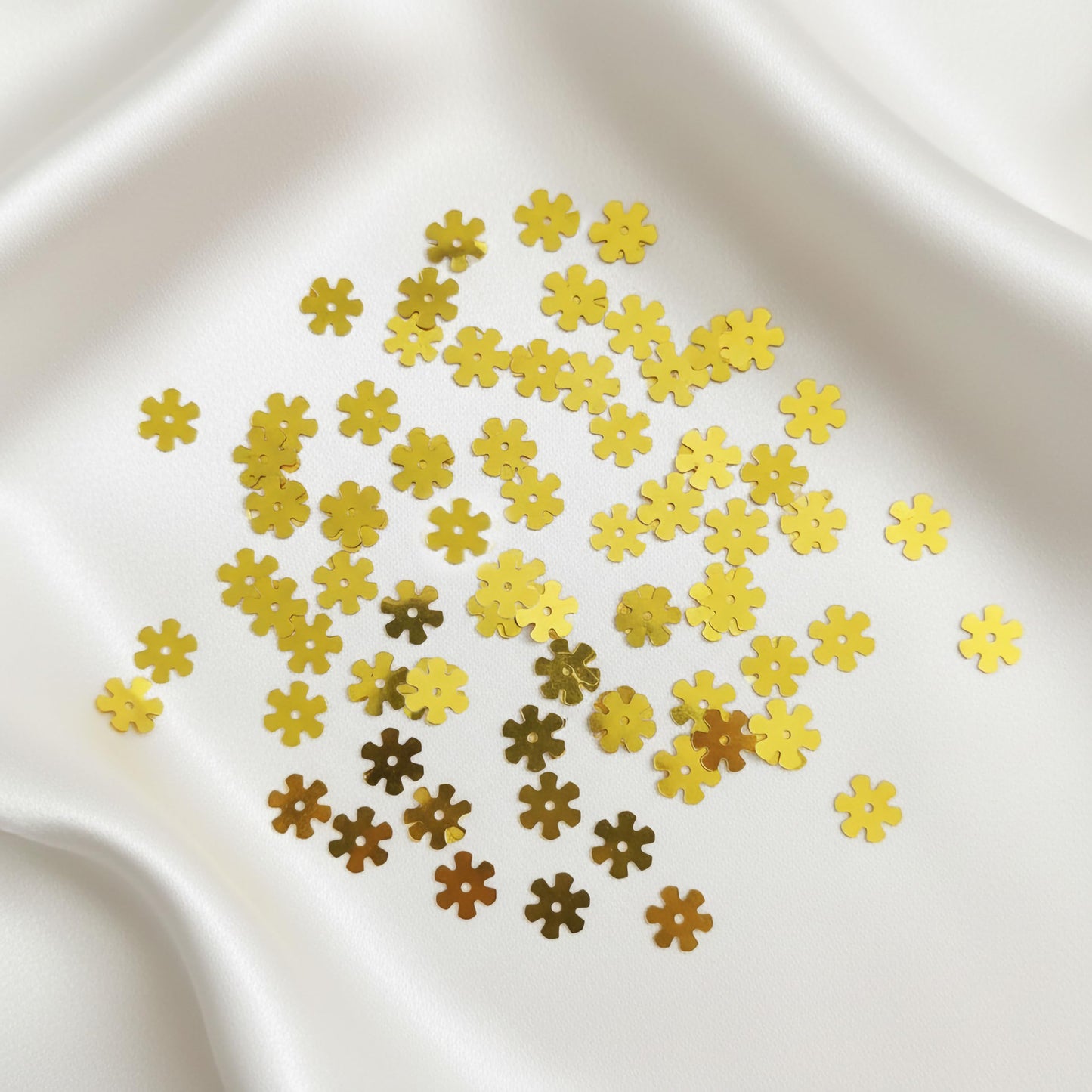 Add metallic texture to dress decoration and boutique craft projects with shiny gold flower embroidery sequins.