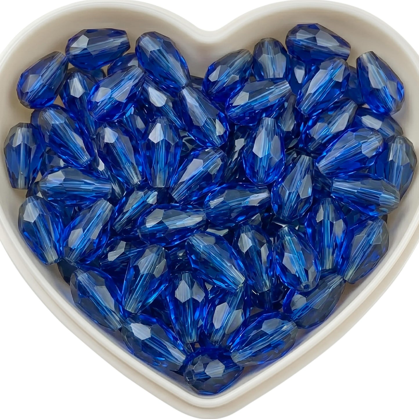 Add graceful dangle accents to earrings and charms with 10x6mm blue faceted teardrop beads.