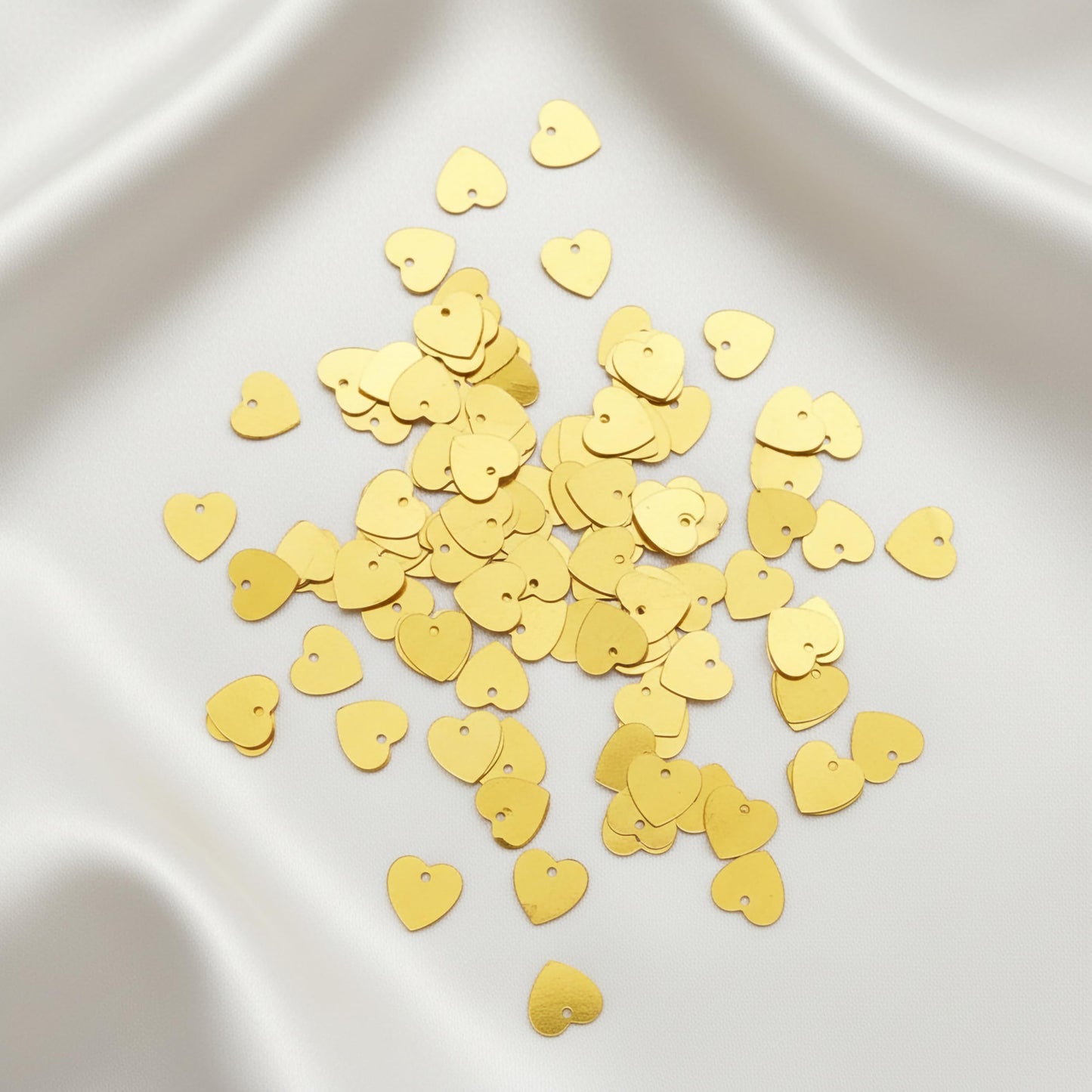 Add a ready-to-use accent to dress decoration with shiny gold aari work sparkle pieces for boutique craft projects.