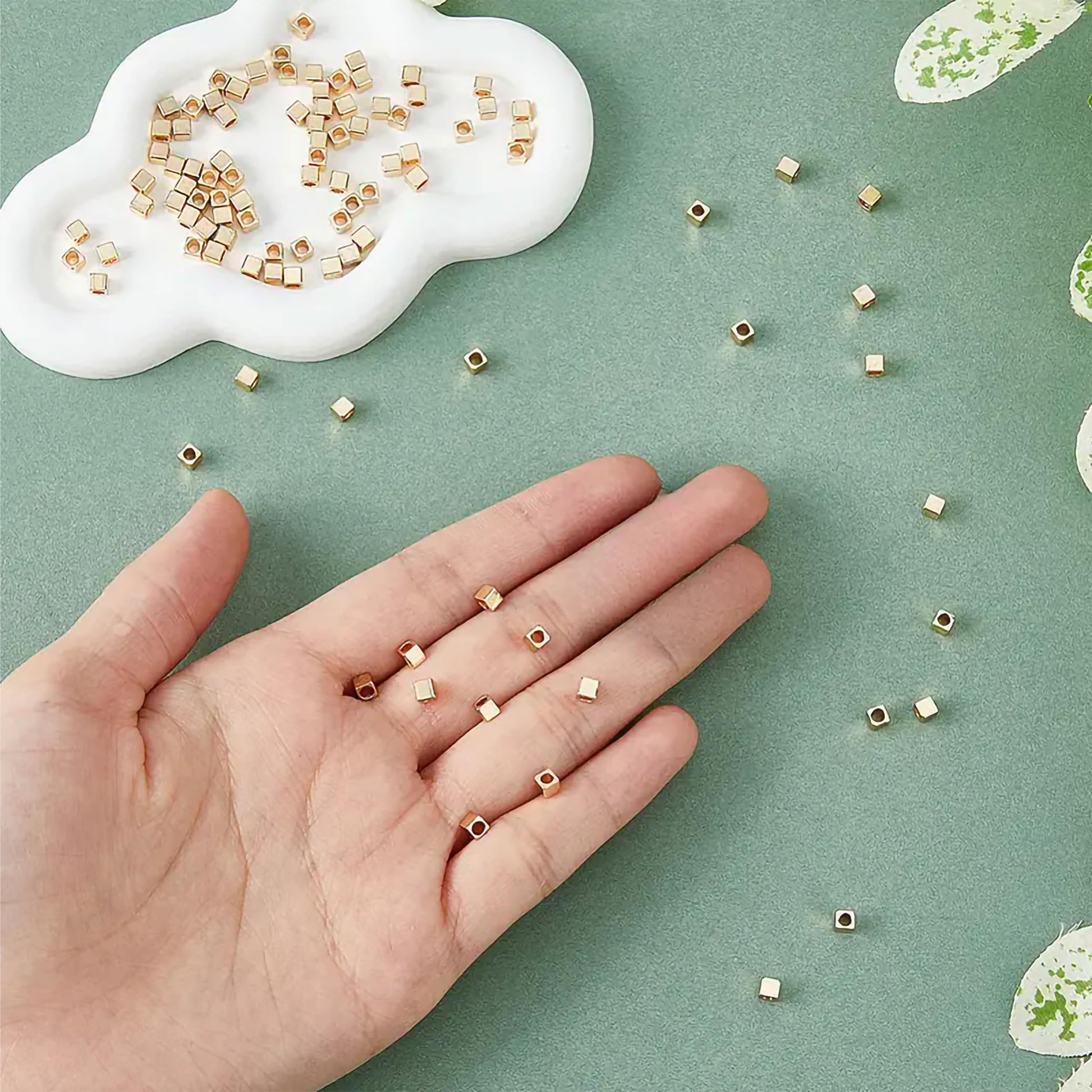 Cube gold and silver plastic and acrylic beads offer a neat decorative finish for DIY jewellery projects, beading craft and decorative craft finishing.