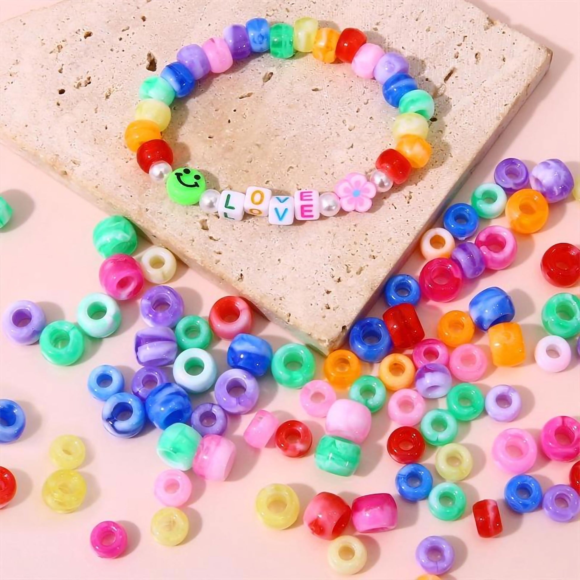 Multicolor DIY Phone Charm Making Kit with Beads and Charms. Assorted layout image showing beads organized for bracelet and DIY projects.