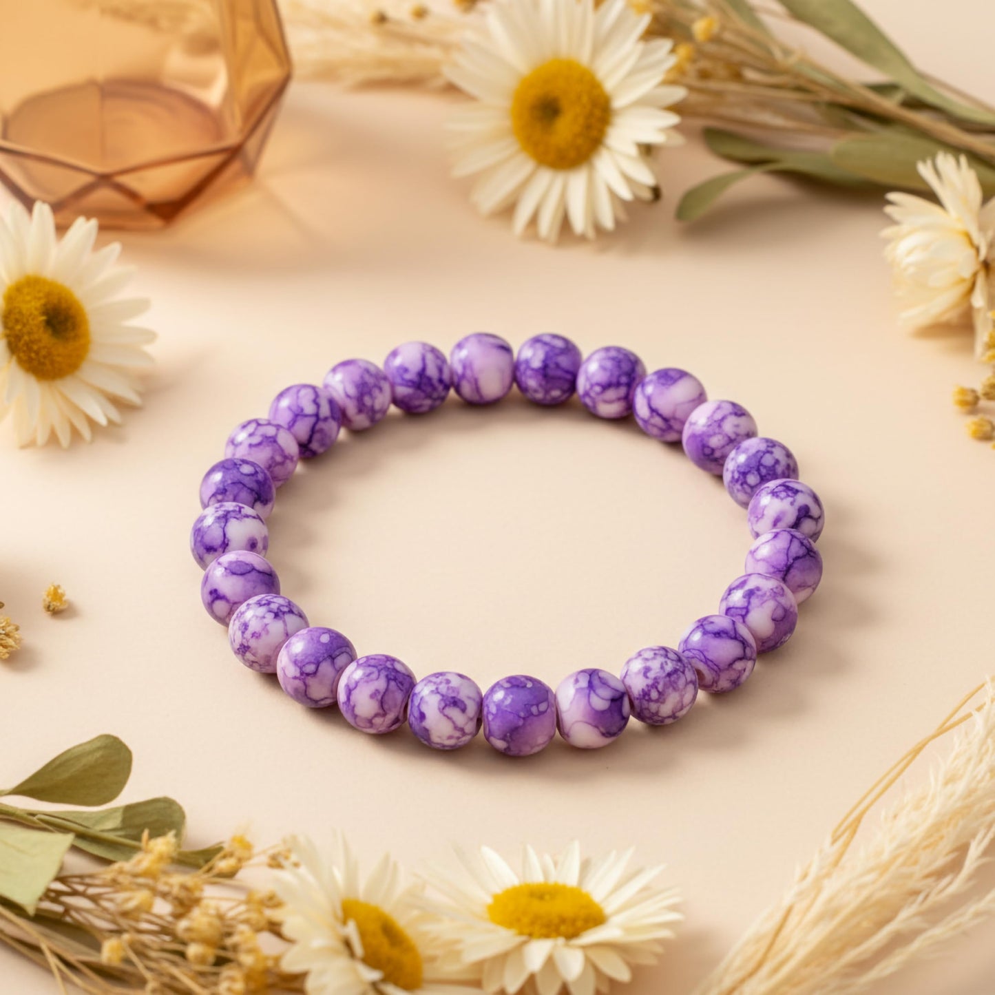 Bring playful color texture to stacked bracelets with purple rounded marble-style beads.