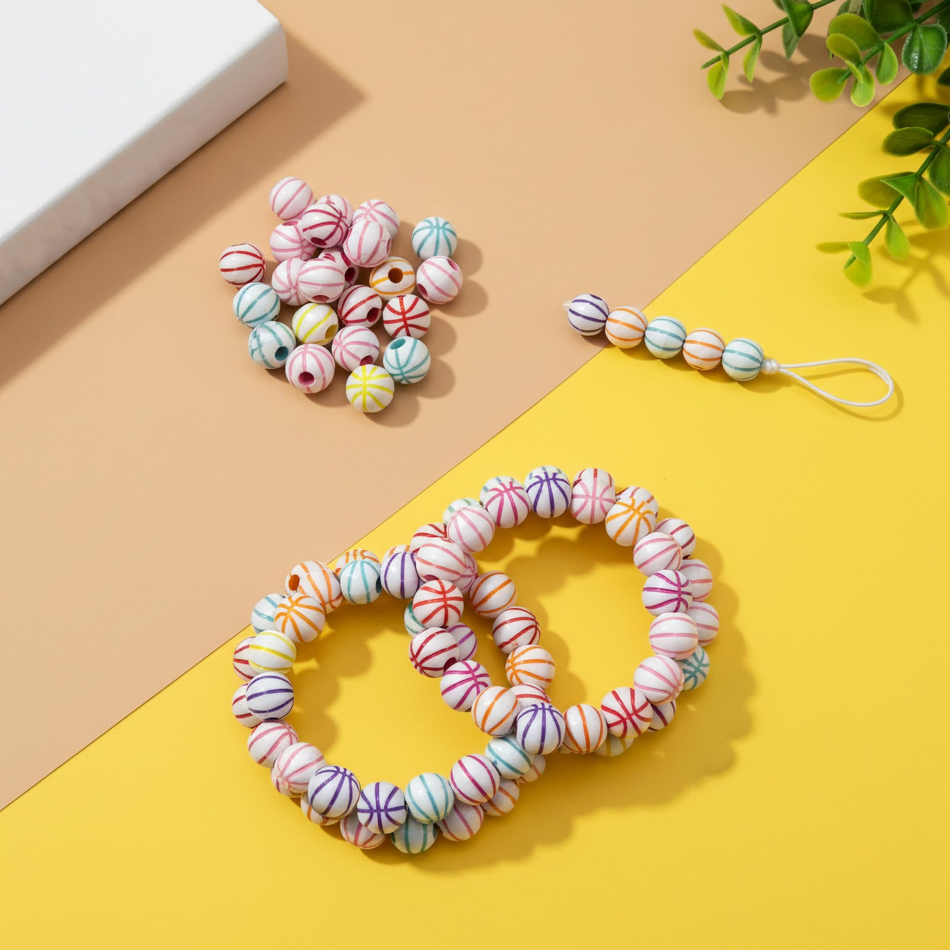Round acrylic beads with rainbow stripe design in white