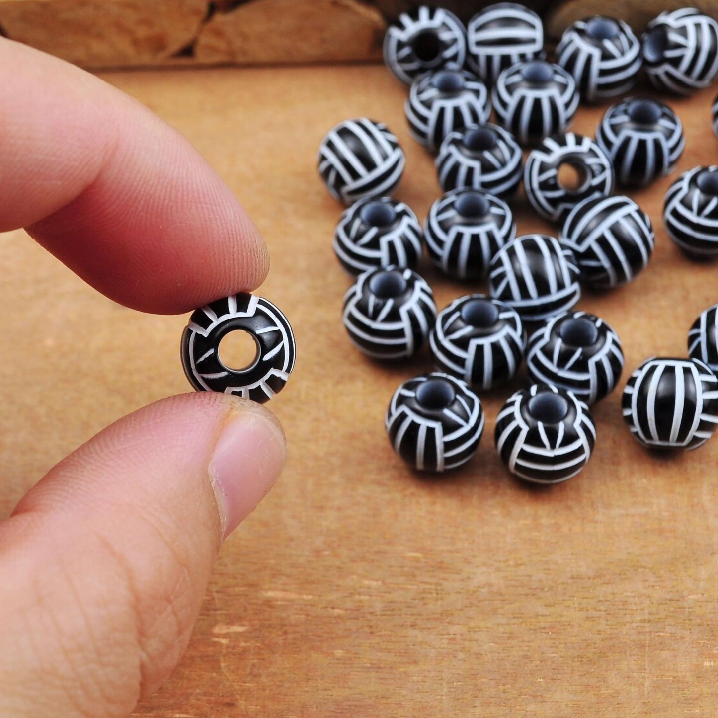 DIY craft beads with monochrome volleyball pattern design