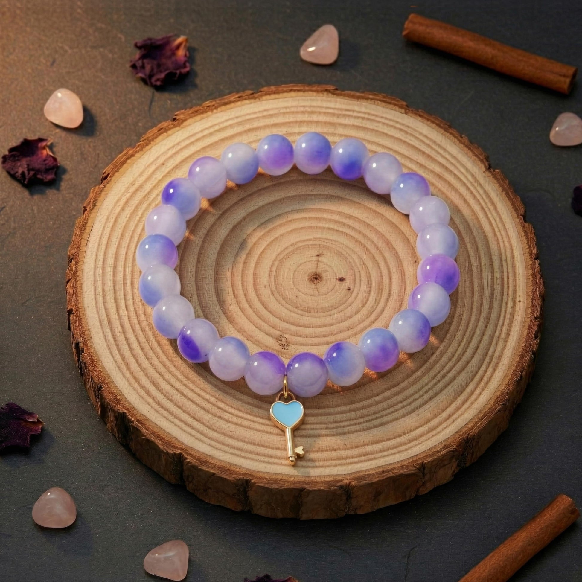 Layer cute wrist stacks with purple dualtone bead details and charm accents.