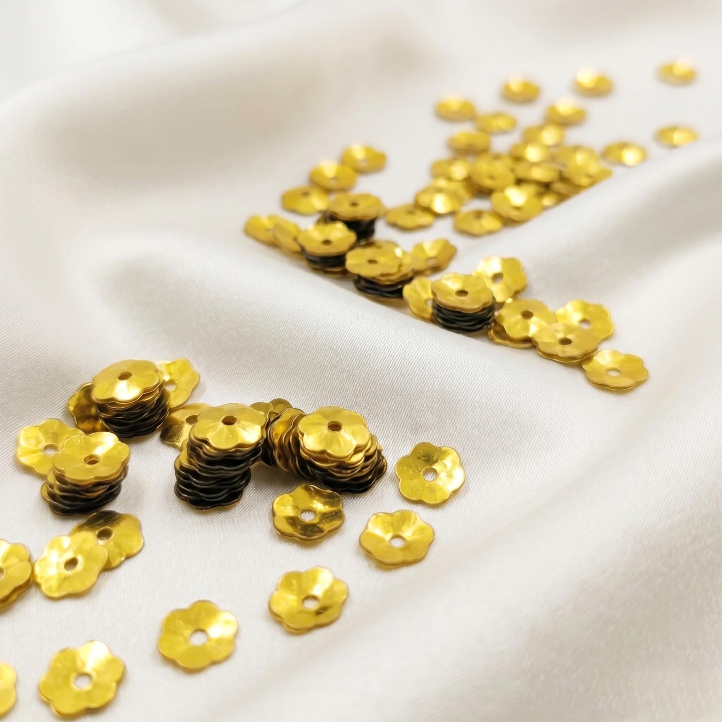 Make dress decoration look more detailed with festive gold flower embroidery sequins for boutique craft projects.