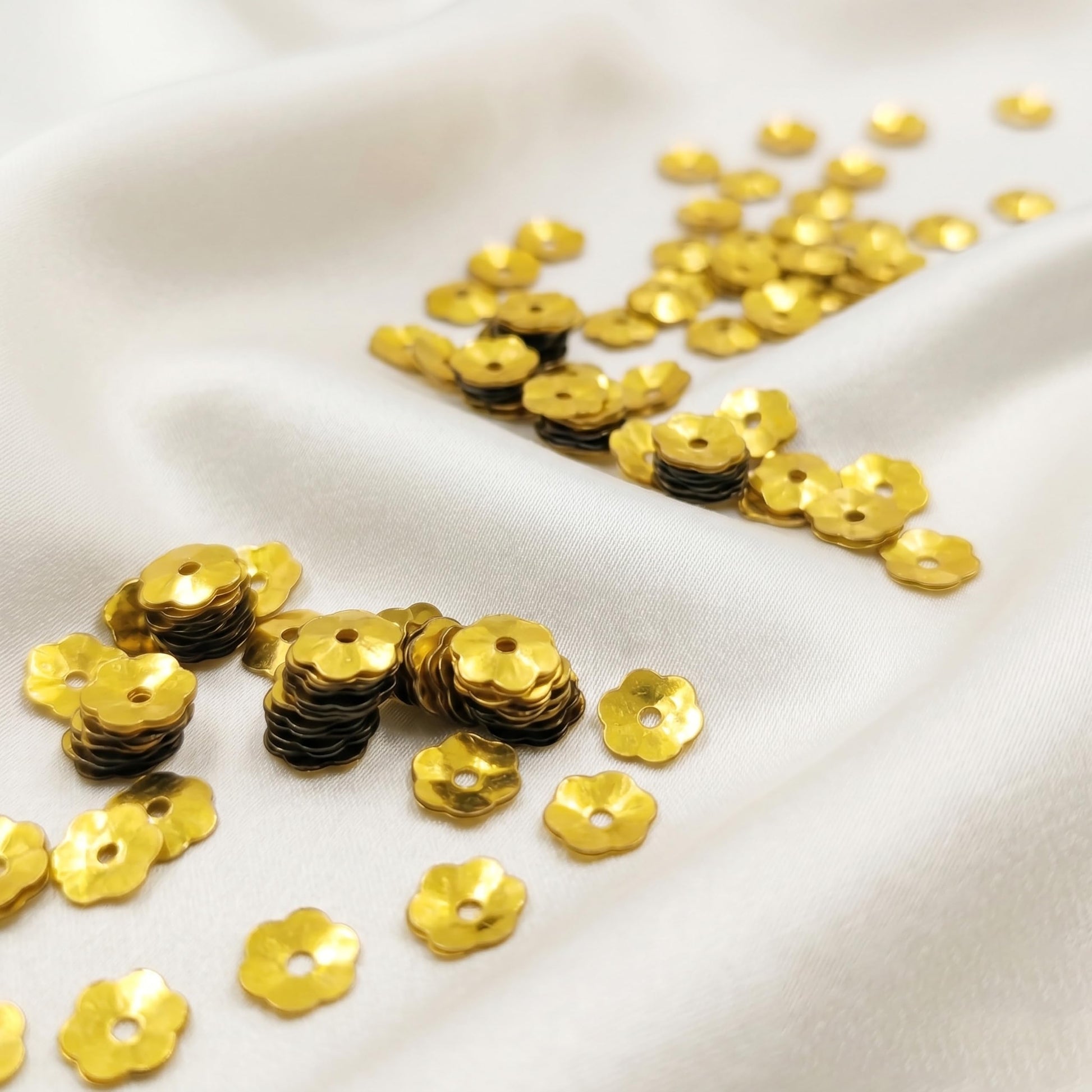 Make dress decoration look more detailed with festive gold flower embroidery sequins for boutique craft projects.