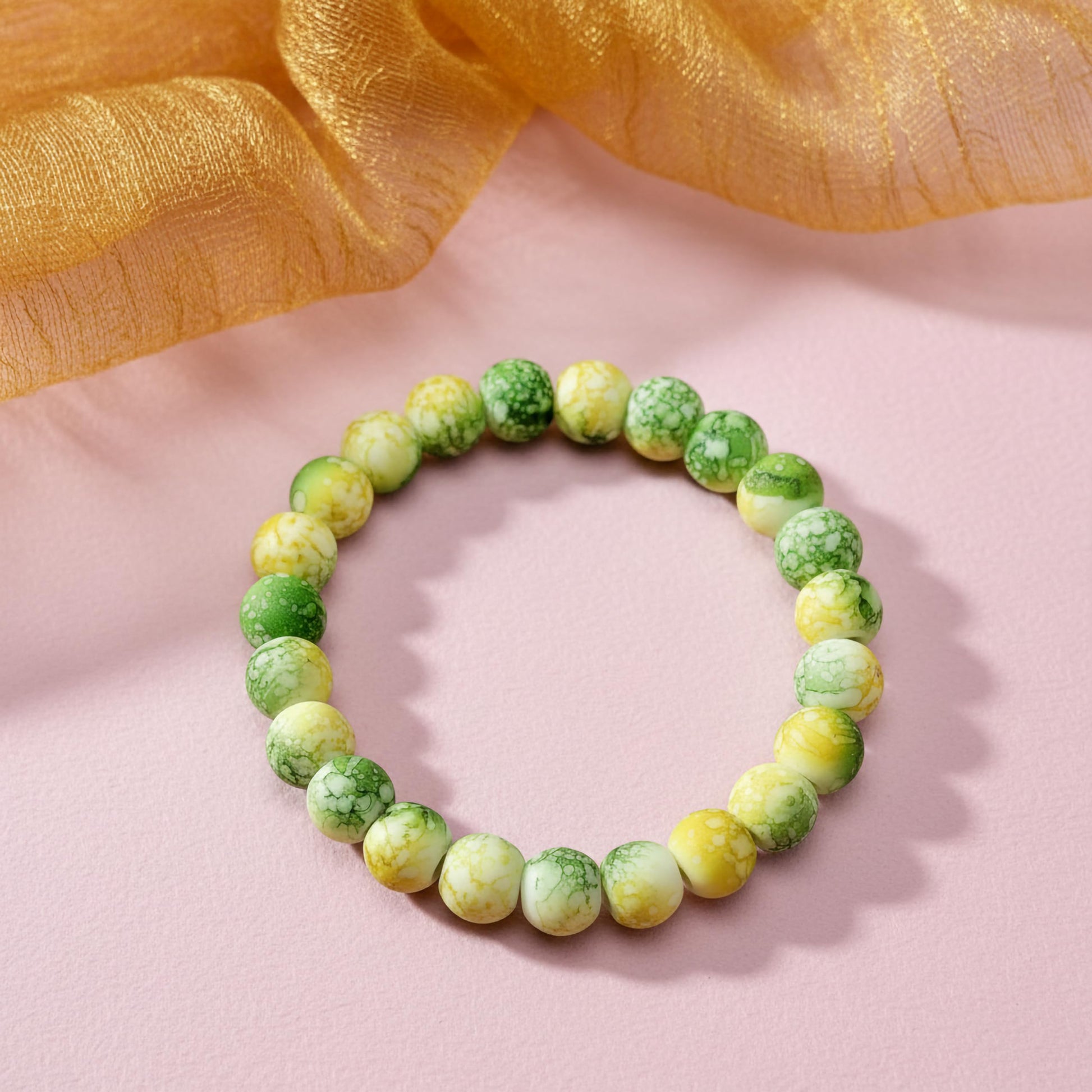 Bring playful color texture to stacked bracelets with yellow and green rounded marble-style beads.