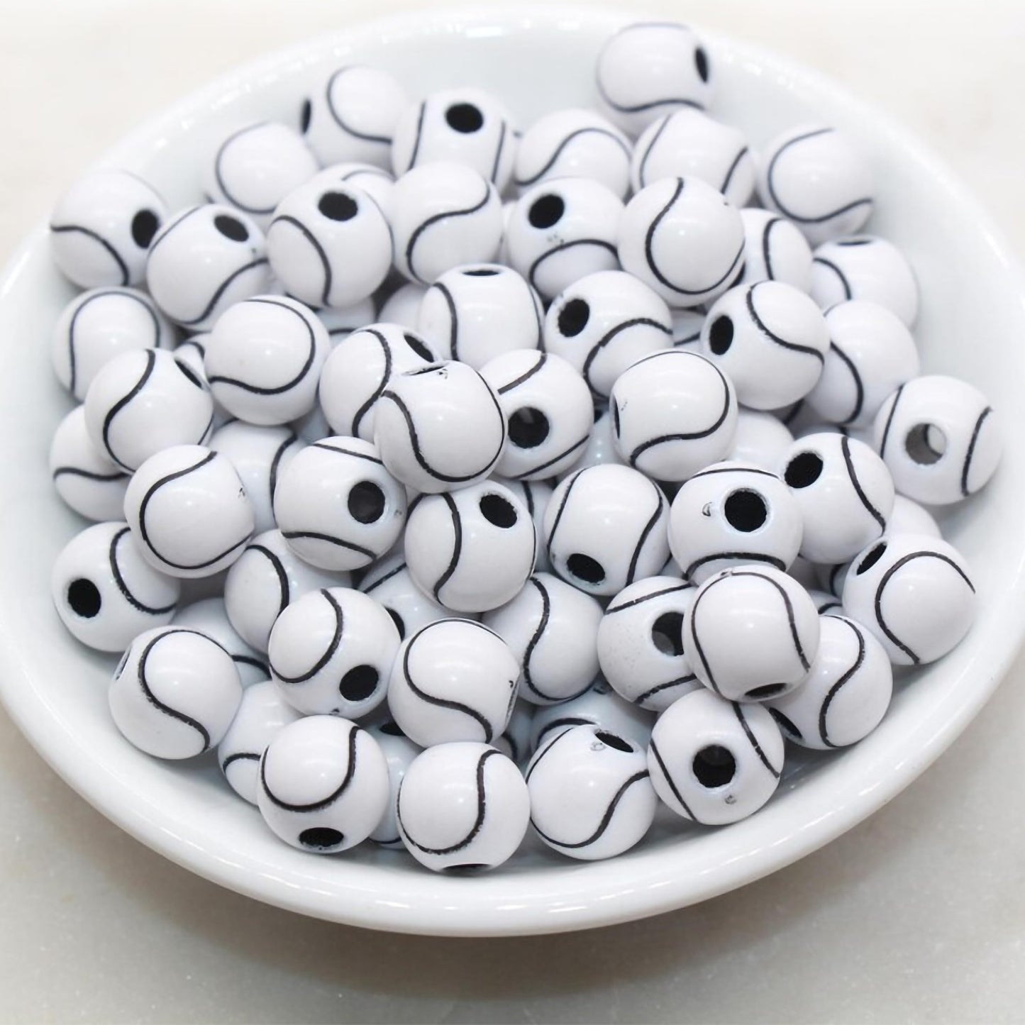 White round beads with black  curved line pattern