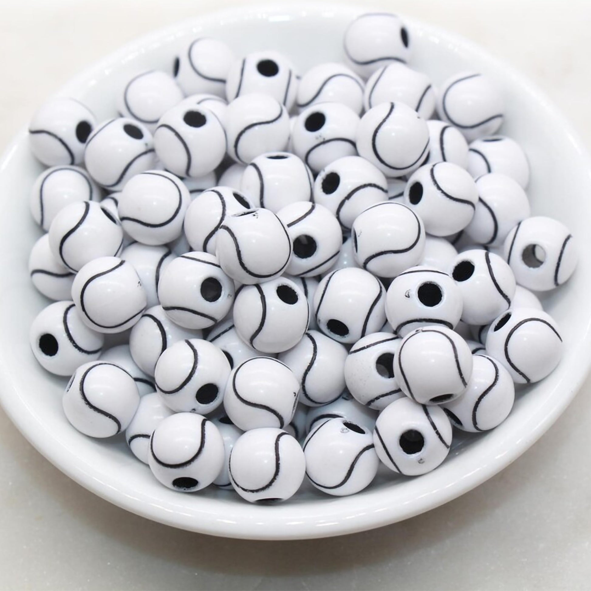 White round beads with black  curved line pattern
