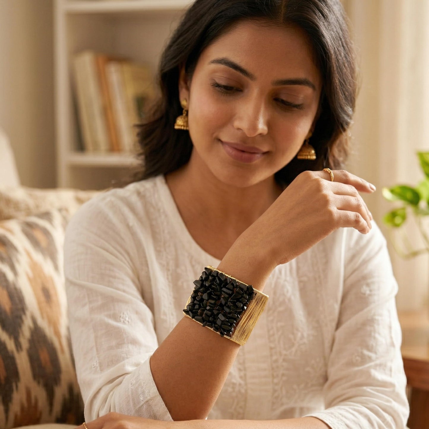 Add a bold handmade accent to outfits using a black chunky stone cuff bracelet.
