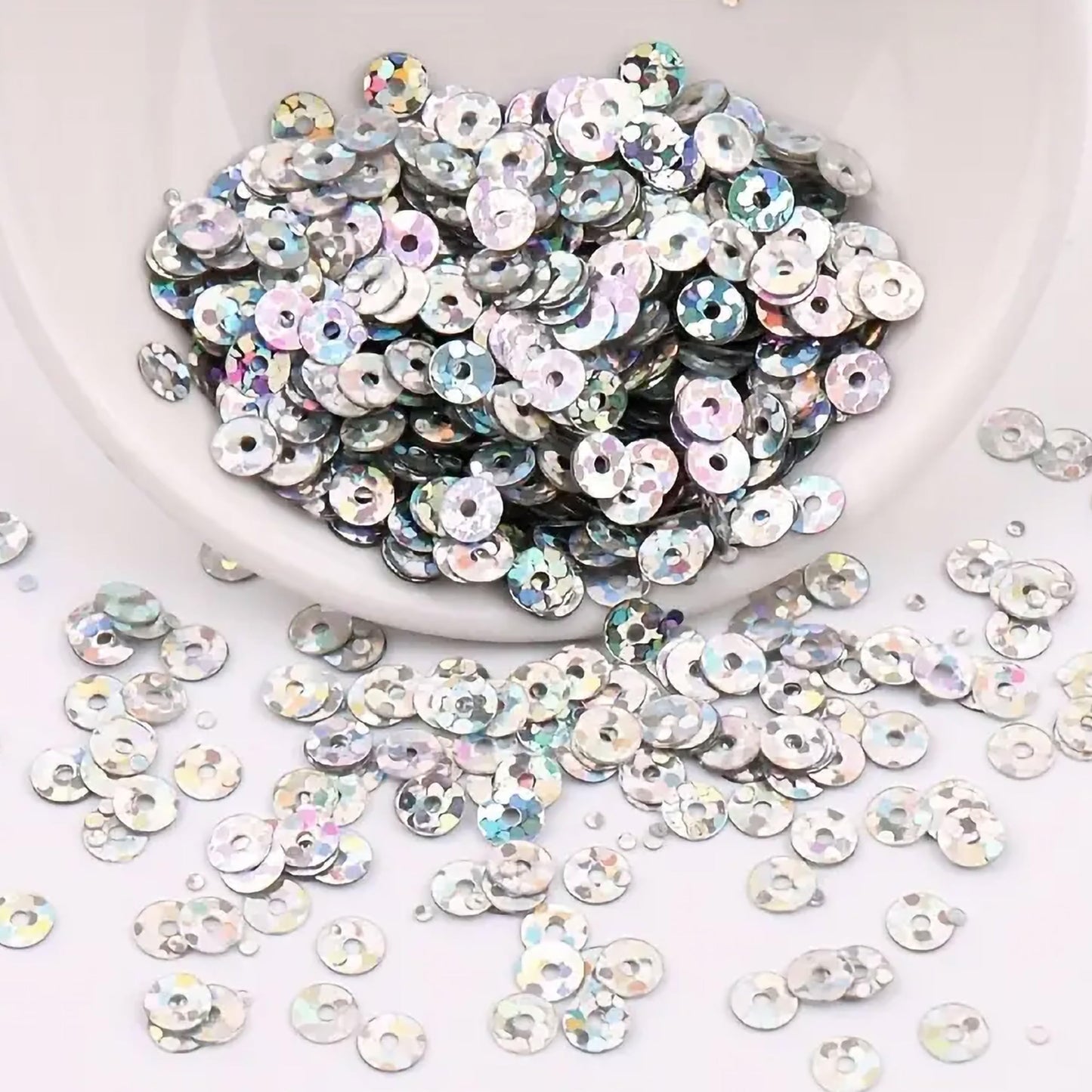 Silver 4mm sequins round shape 4mm sitara sequins with holes give Embroidery for embroidery, craft decoration and fabric embellishment a neat visual lift.