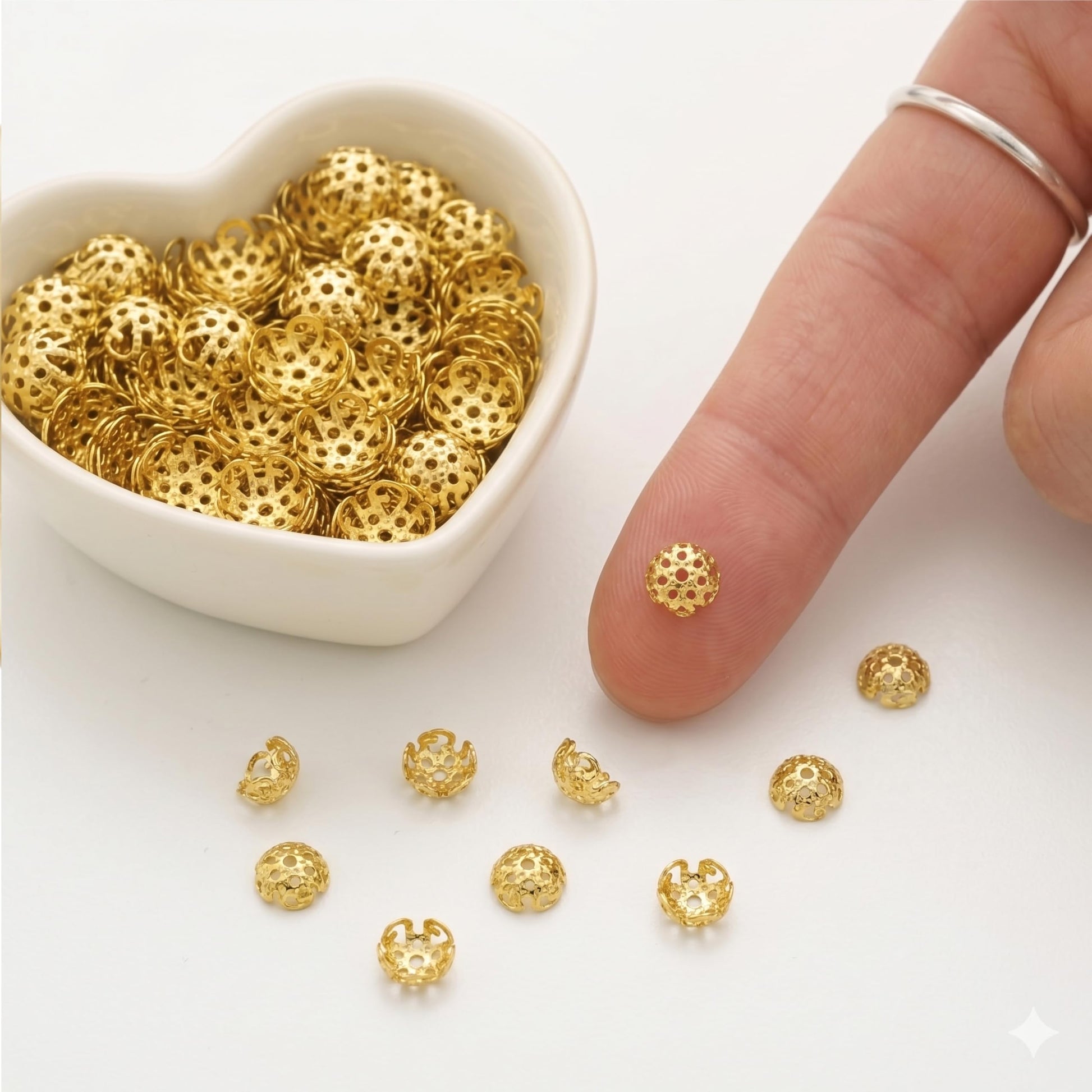 Metallic gold jhumka cap findings turn saree kuchu craft into more expressive craft work.