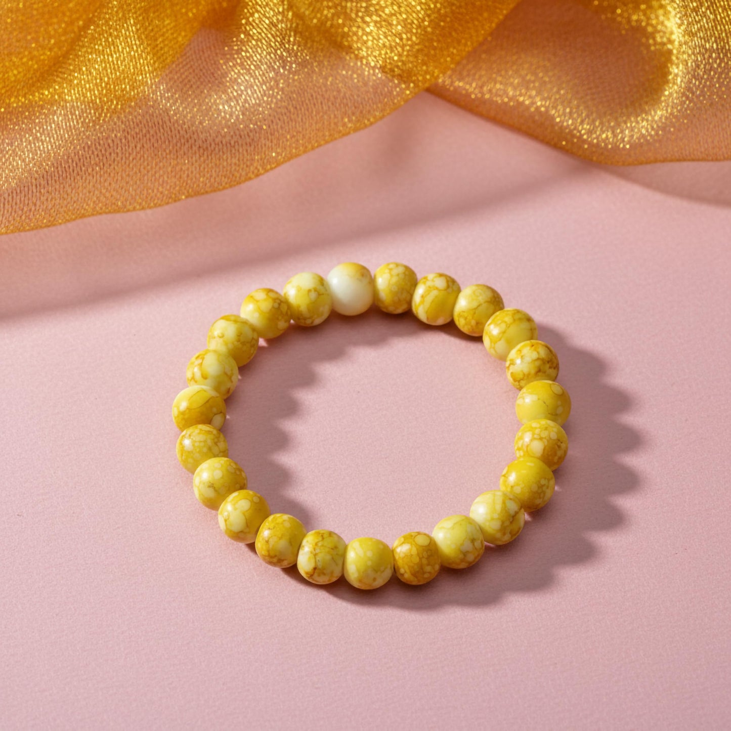 Bring playful color texture to stacked bracelets with yellow rounded marble-style beads.