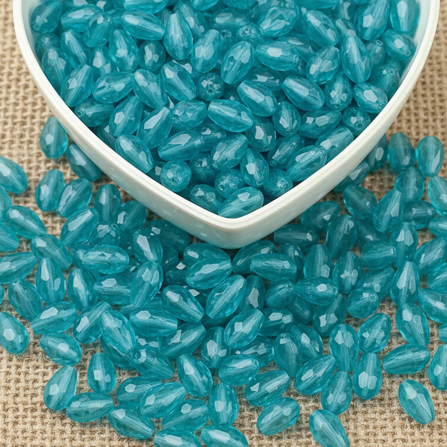 Design delicate charms, anklets and earrings with 15x10mm cyan cut-facet teardrop beads.